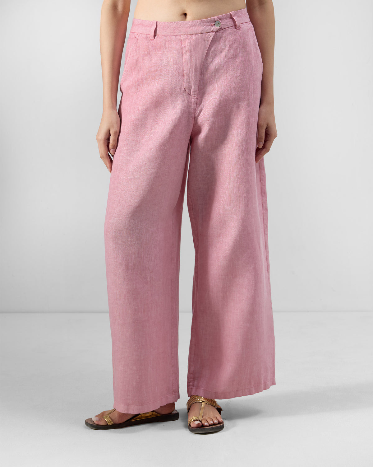 Person wearing soft pink Aven linen pants with a wide A-line leg.