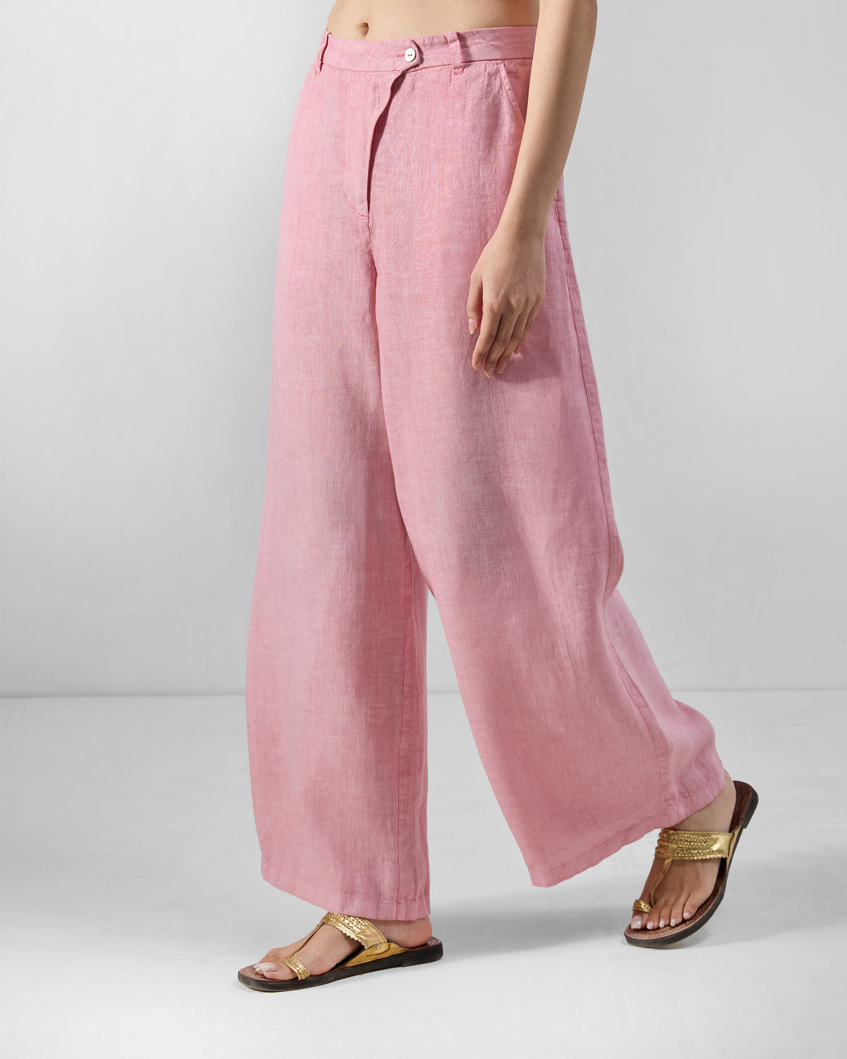 Side view of soft pink Aven linen pants showing the wide-leg drape.