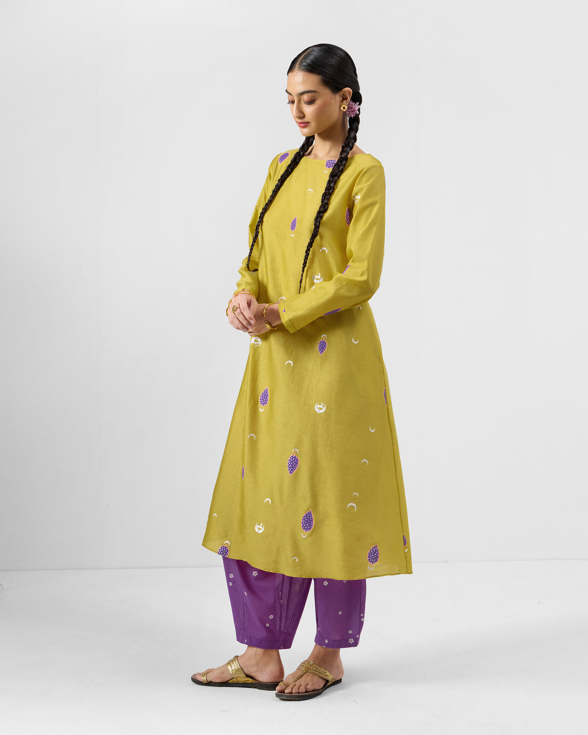 Person wearing a chartreuse Boat Neck Kurta with purple and white embroidery.