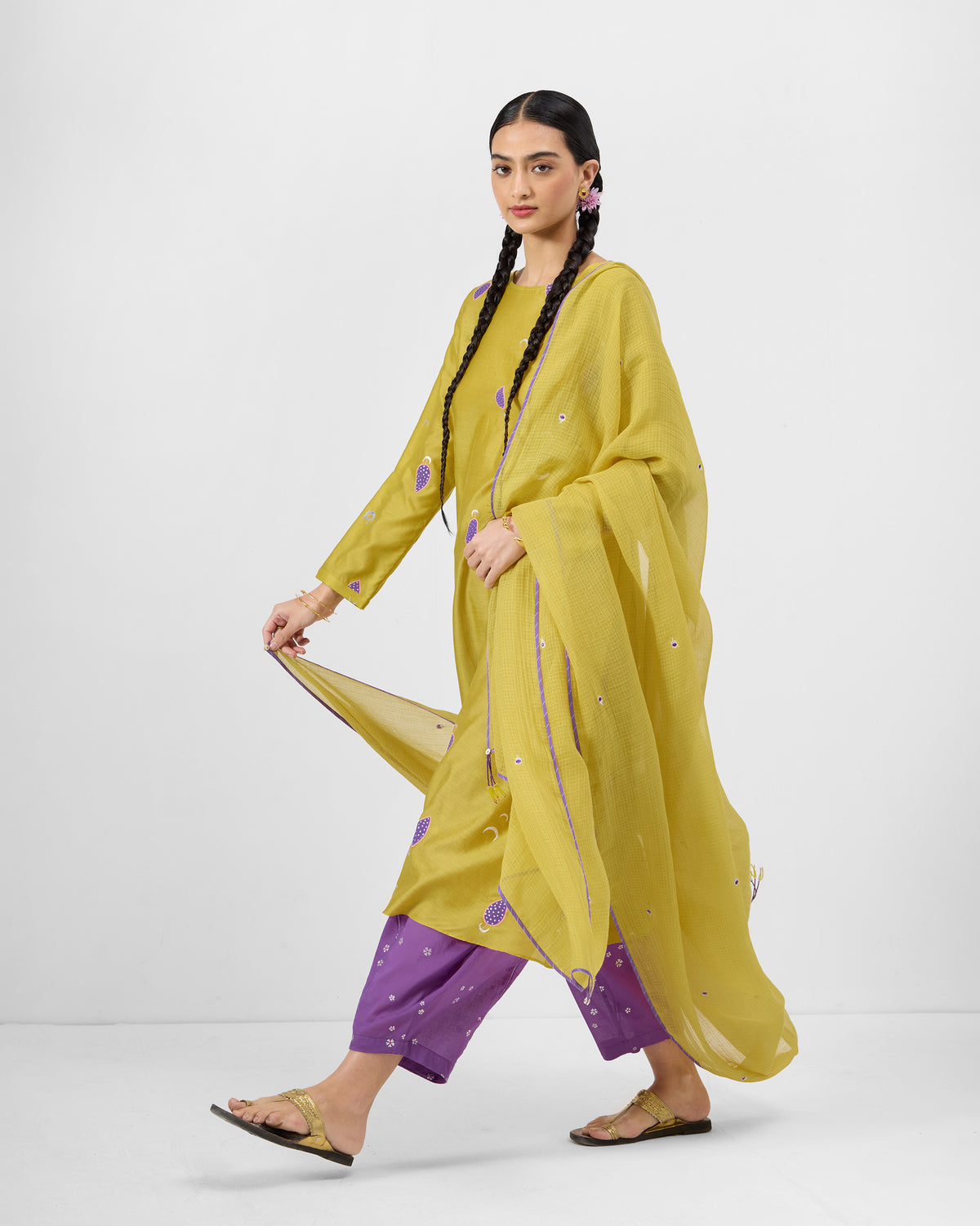 Person walking in a chartreuse Boat Neck Kurta with a matching dupatta.