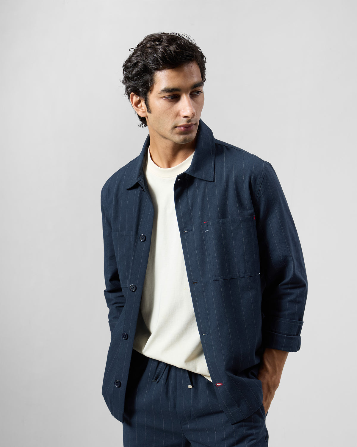 Navy pinstripe Rayh shacket with patch pockets worn open.