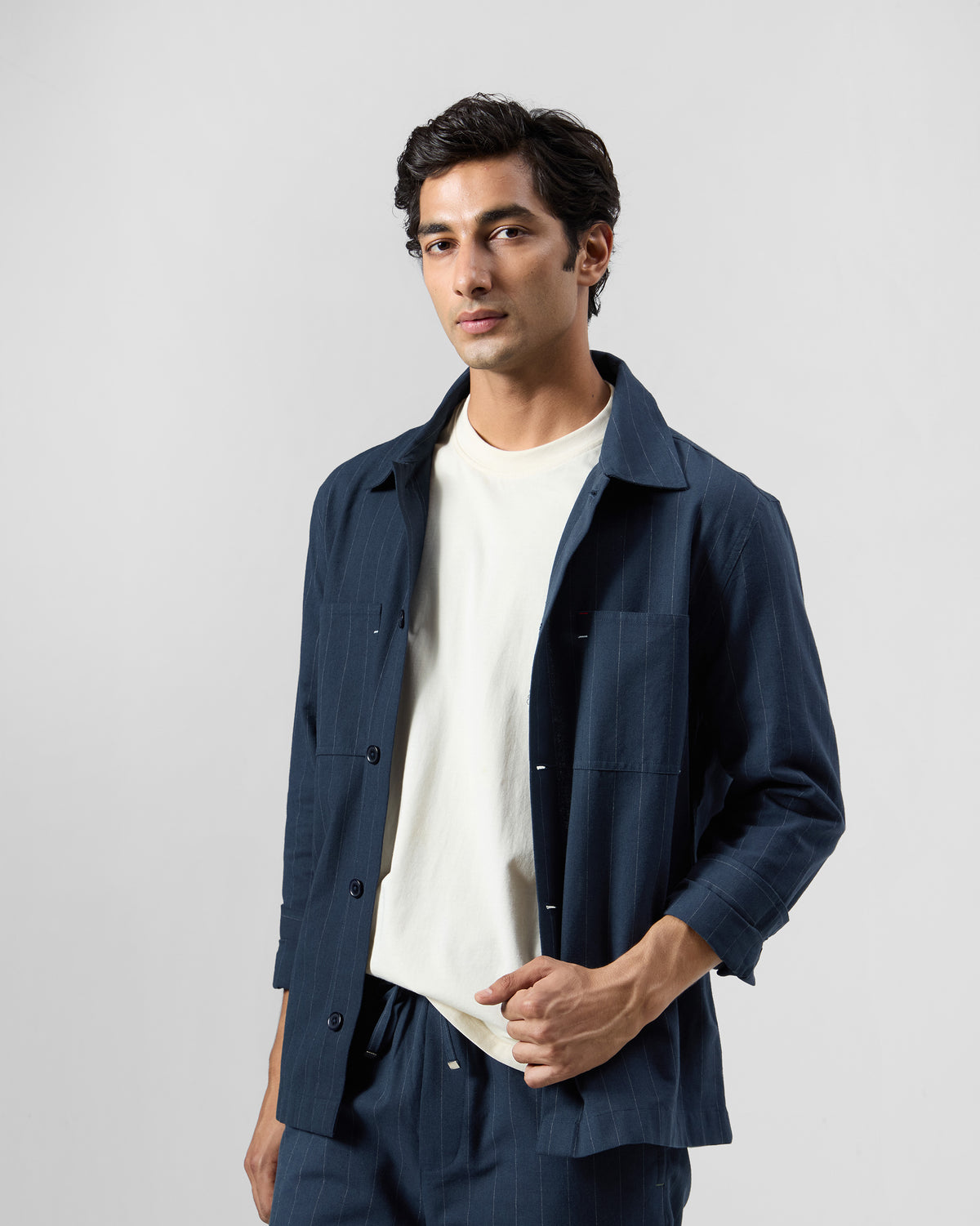Navy pinstripe Rayh shacket worn open over a cream tee.