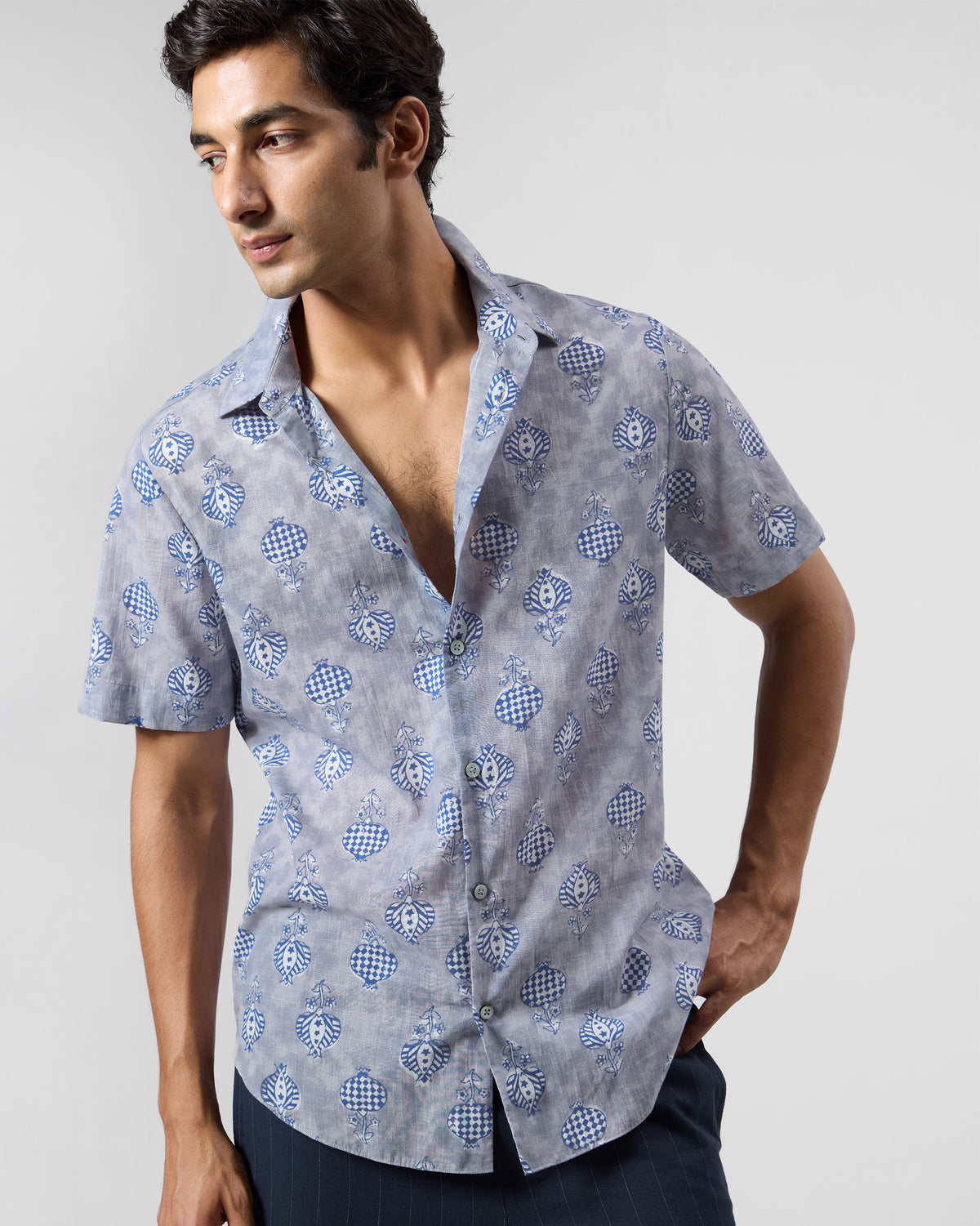 Person wearing a light blue Ganga Shirt with blue block-printed motifs.