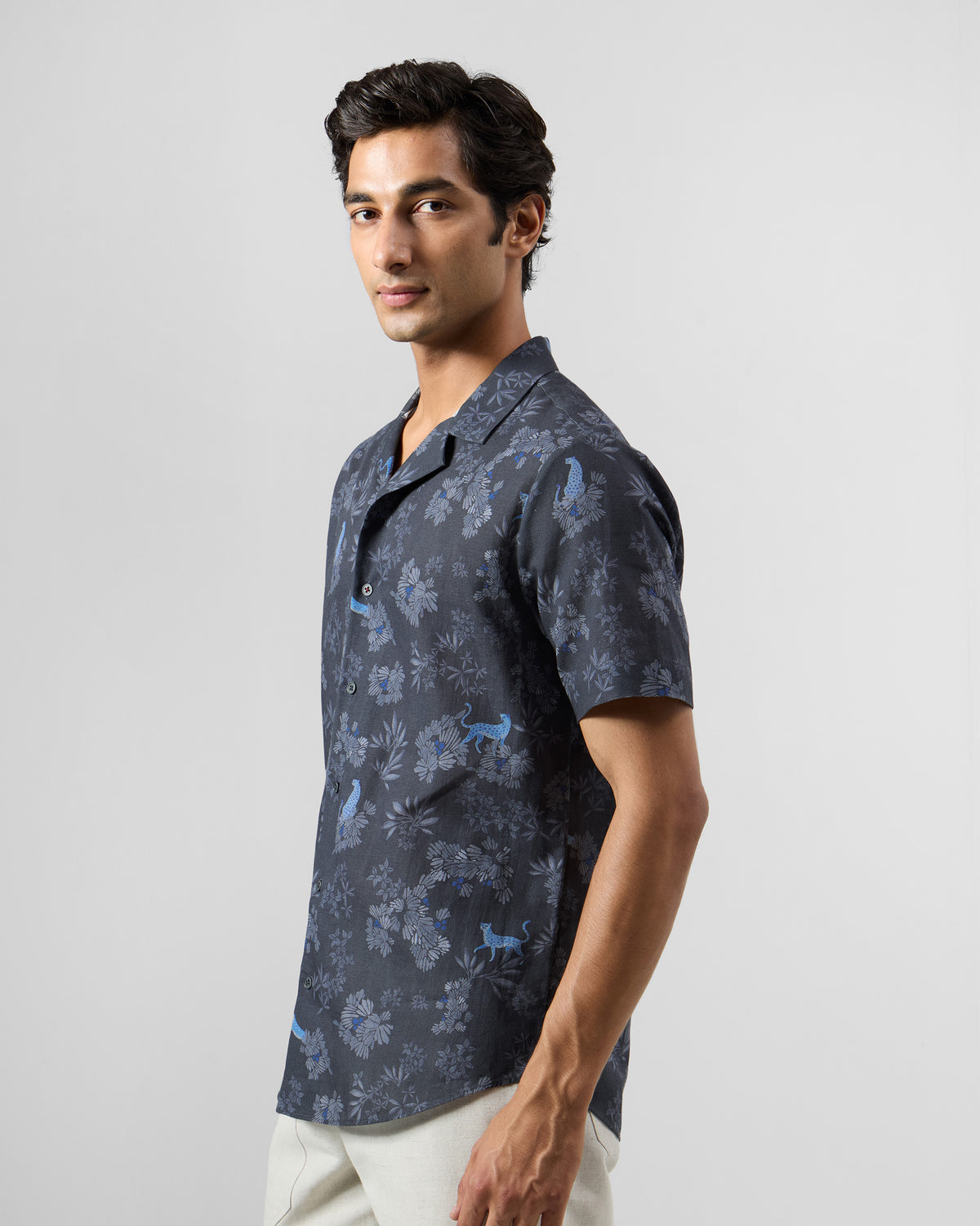 Three-quarter view of a charcoal Mistari Shirt with a blue leopard print.