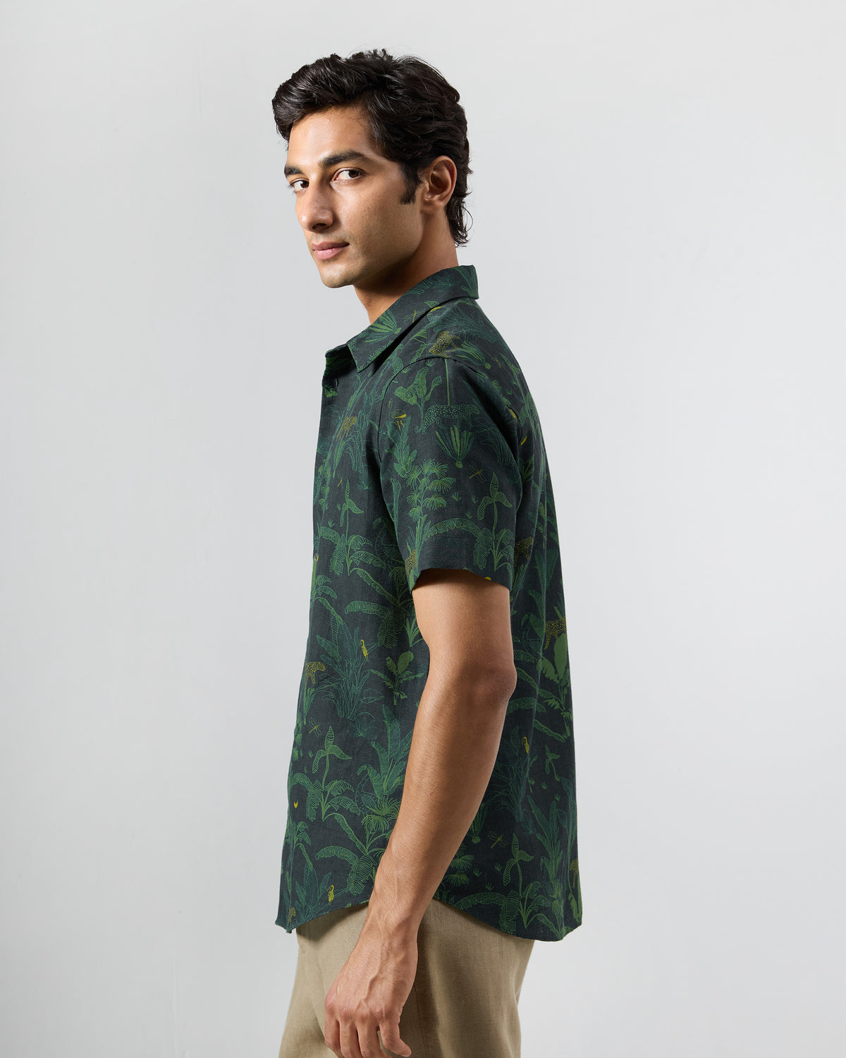 Side view of a green Half Sleeve Shirt with an all-over jungle print.
