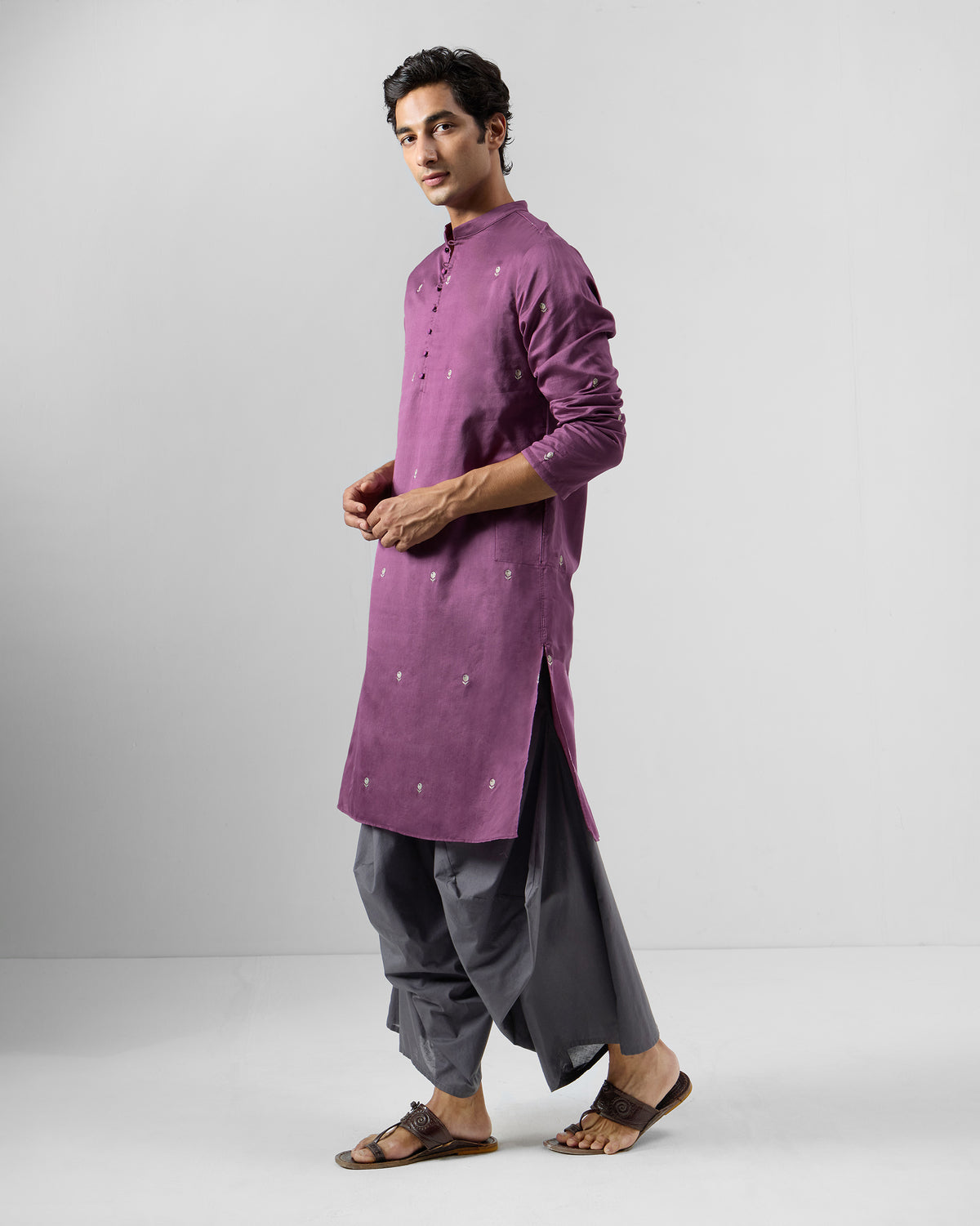 Person wearing a jamun pink Zenith Kurta scattered with white motifs.