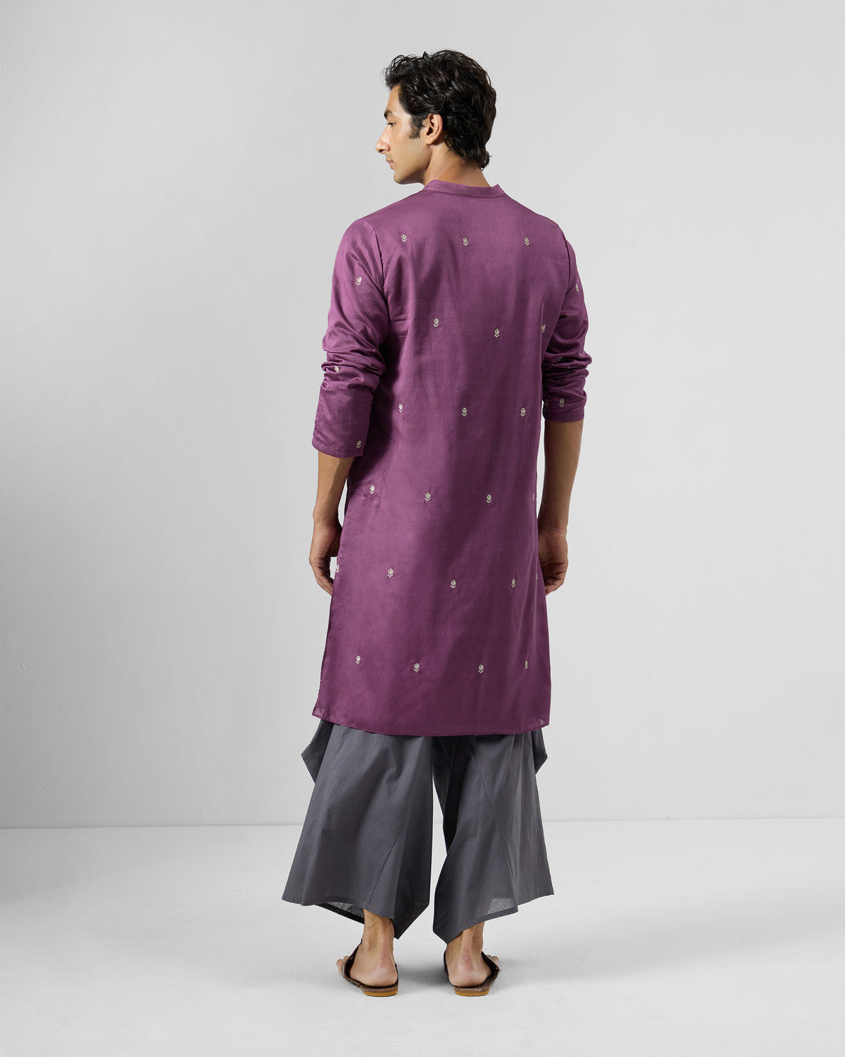Back of a jamun pink Zenith Kurta scattered with white embroidered motifs.
