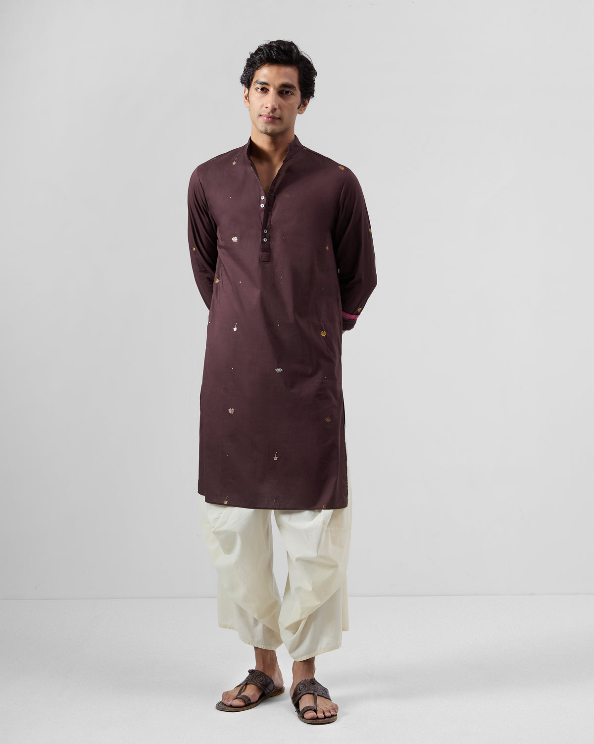 Person wearing a wine Rey Kurta with scattered gold foil motifs.