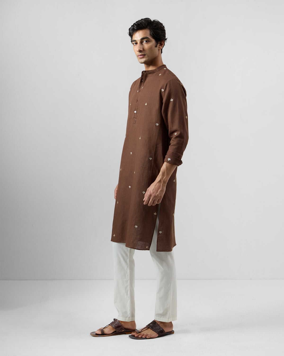 Side view of a brown Astral kurta with scattered chinar leaf embroidery.
