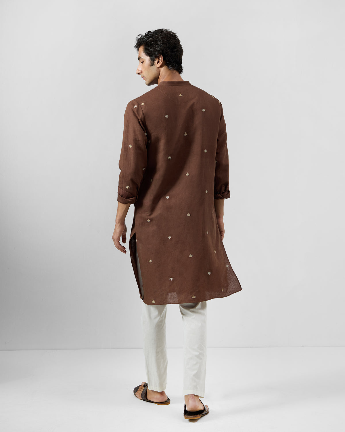 Back of a brown Astral kurta with scattered tonal leaf embroidery.