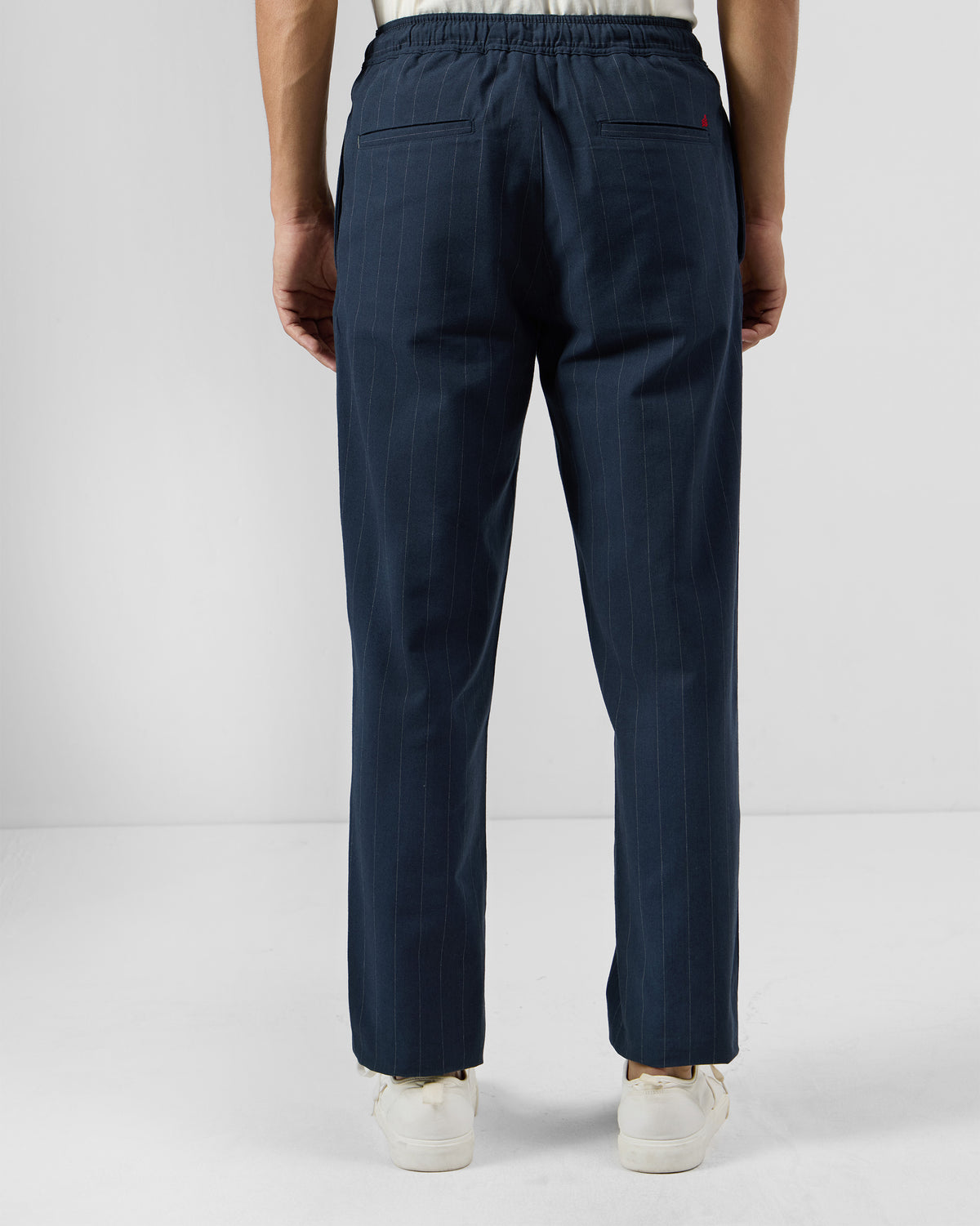 Back of navy pinstripe Vera trousers showing rear welt pockets.