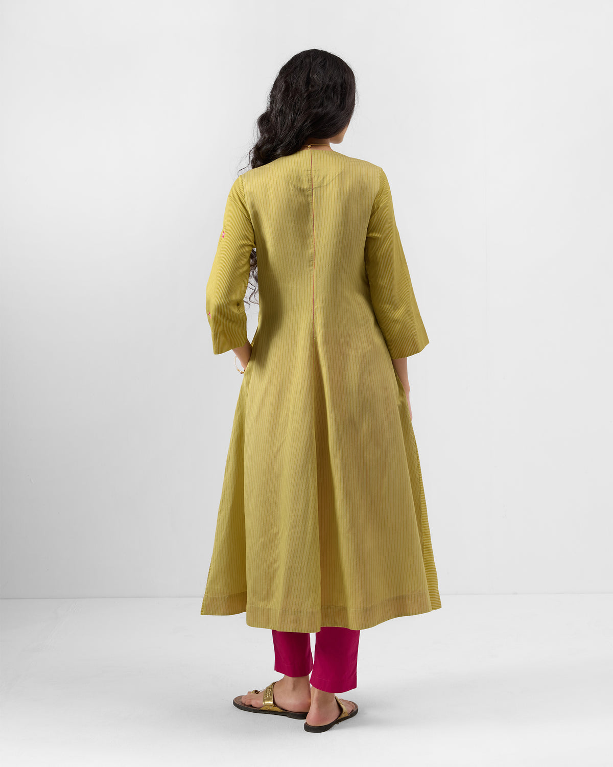 Back of a sand Murud flared kurta with a centre seam and side pocket.