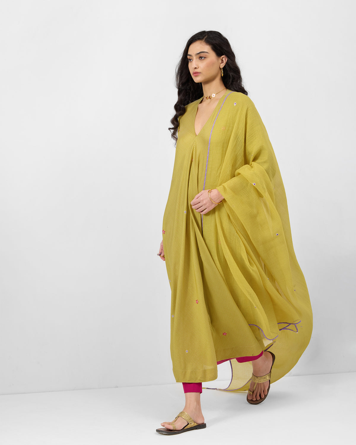 Person wearing a sand Murud flared kurta with a matching embroidered dupatta.