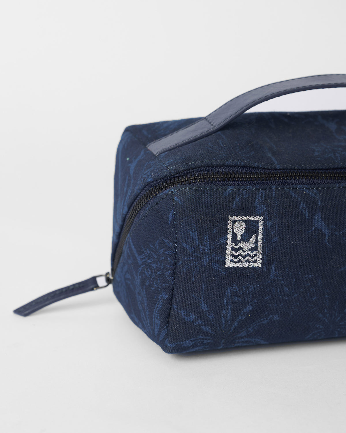 Close-up of a Palm dopp kit showing a hot-air balloon stamp.