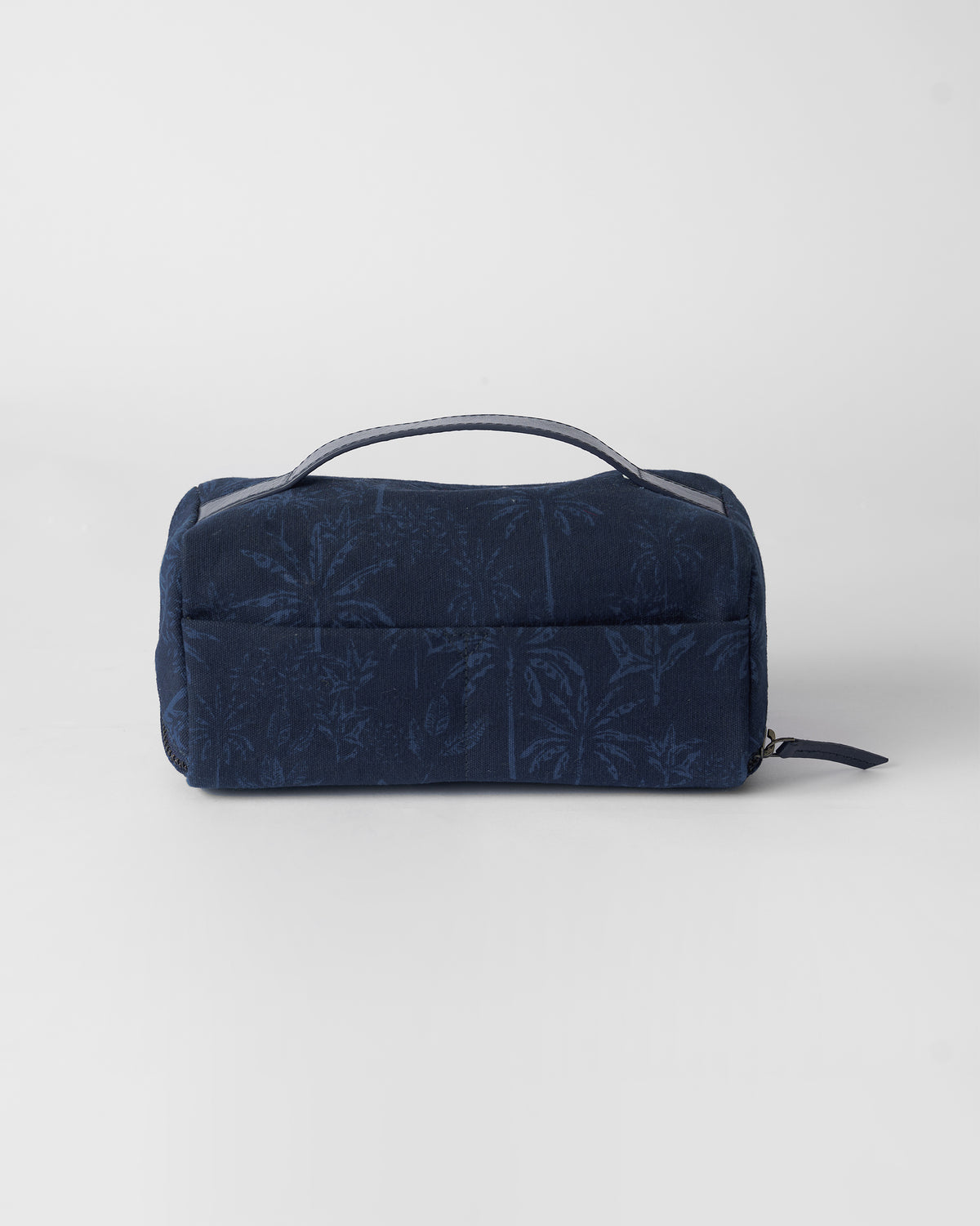Navy Palm dopp kit with a palm print and top handle.