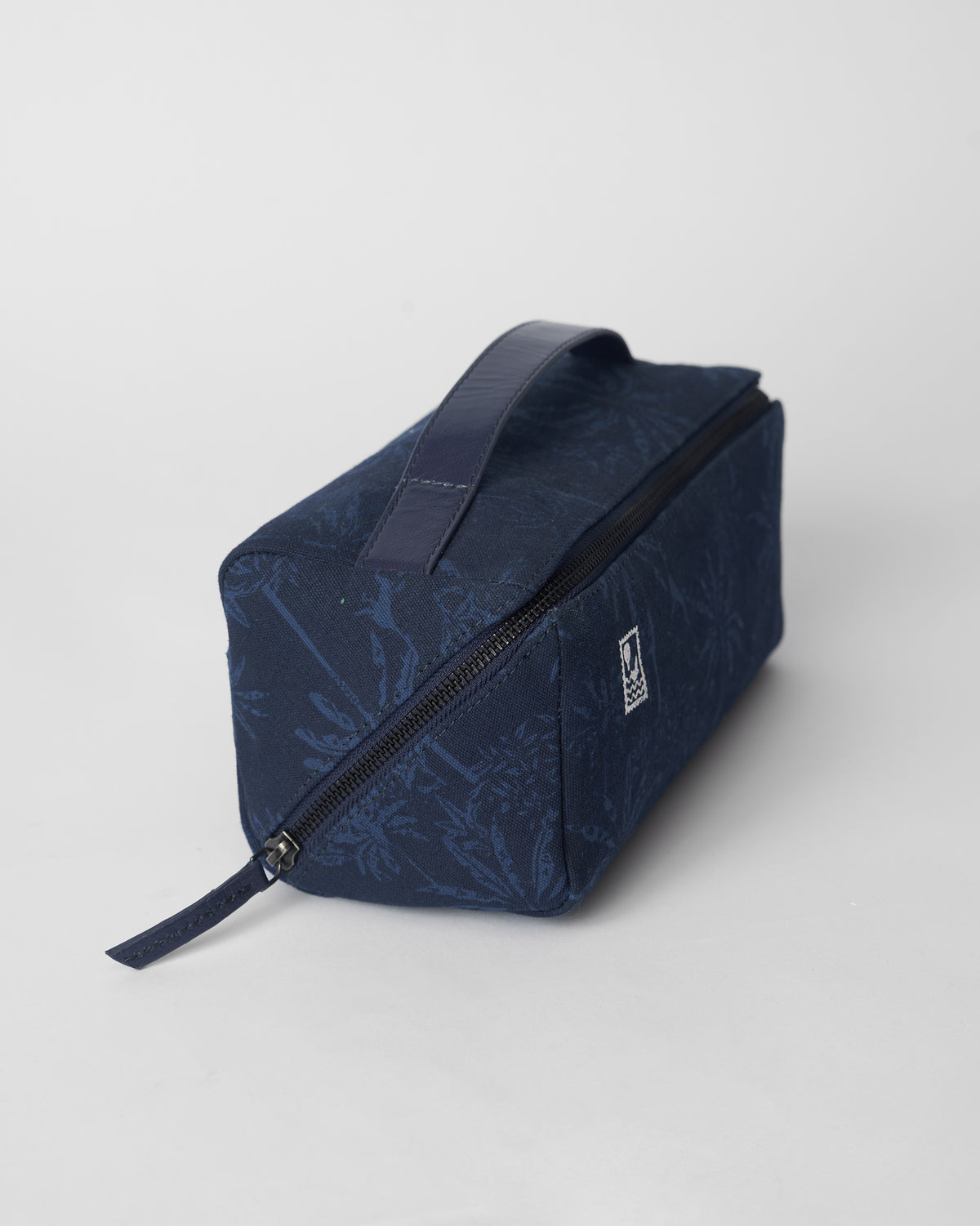 Navy Palm dopp kit with a palm print and leather handle.