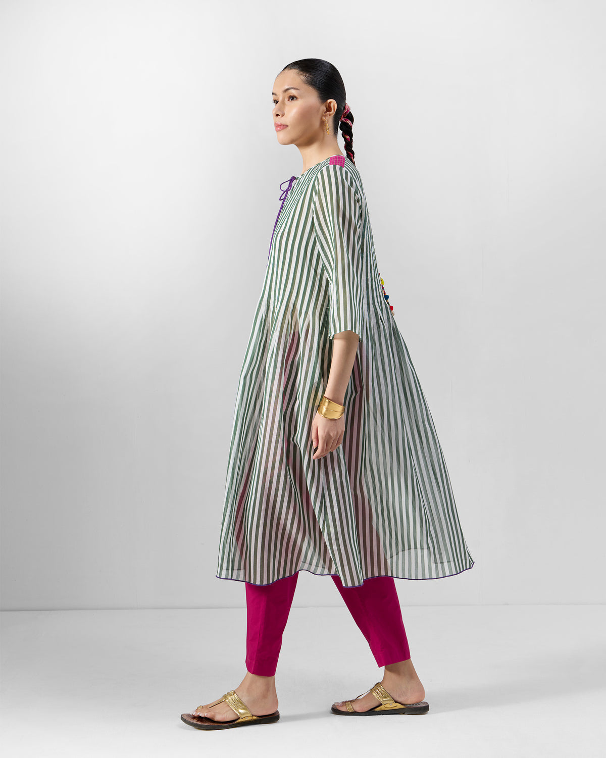 Side view of an emerald-and-ivory striped Konark kurta with an A-line flare.
