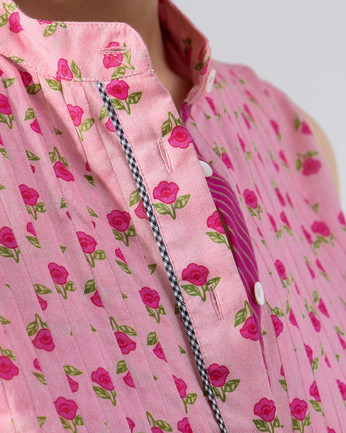 Close-up of pin-tucks and check piping on a pink Summer Fun kurta.