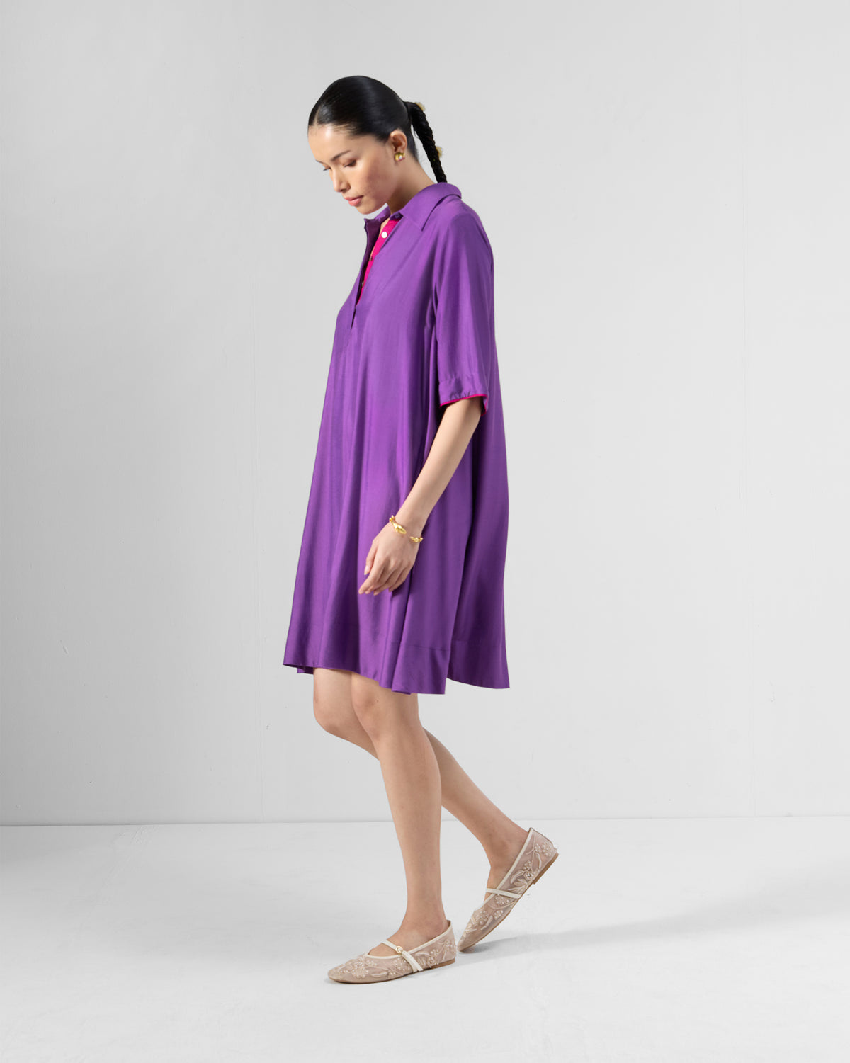 Side view of a purple Happy Heart Dress showing the A-line length and short sleeves.