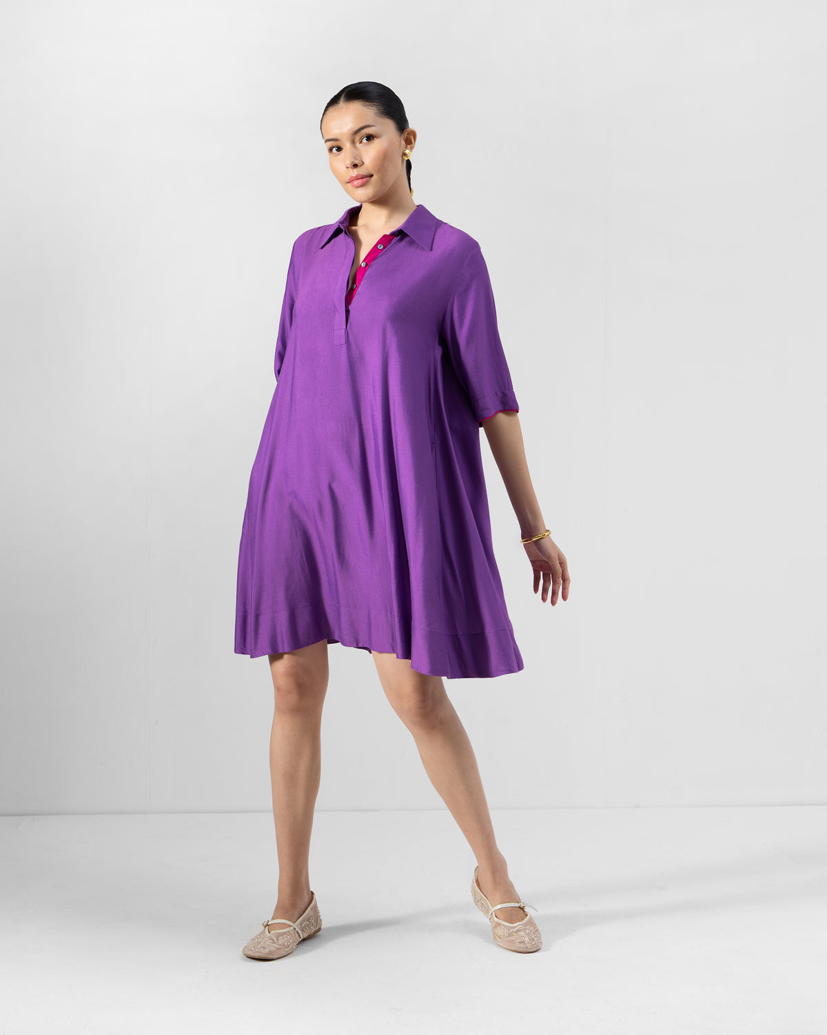 Person wearing a purple Happy Heart Dress with a collared open neckline.