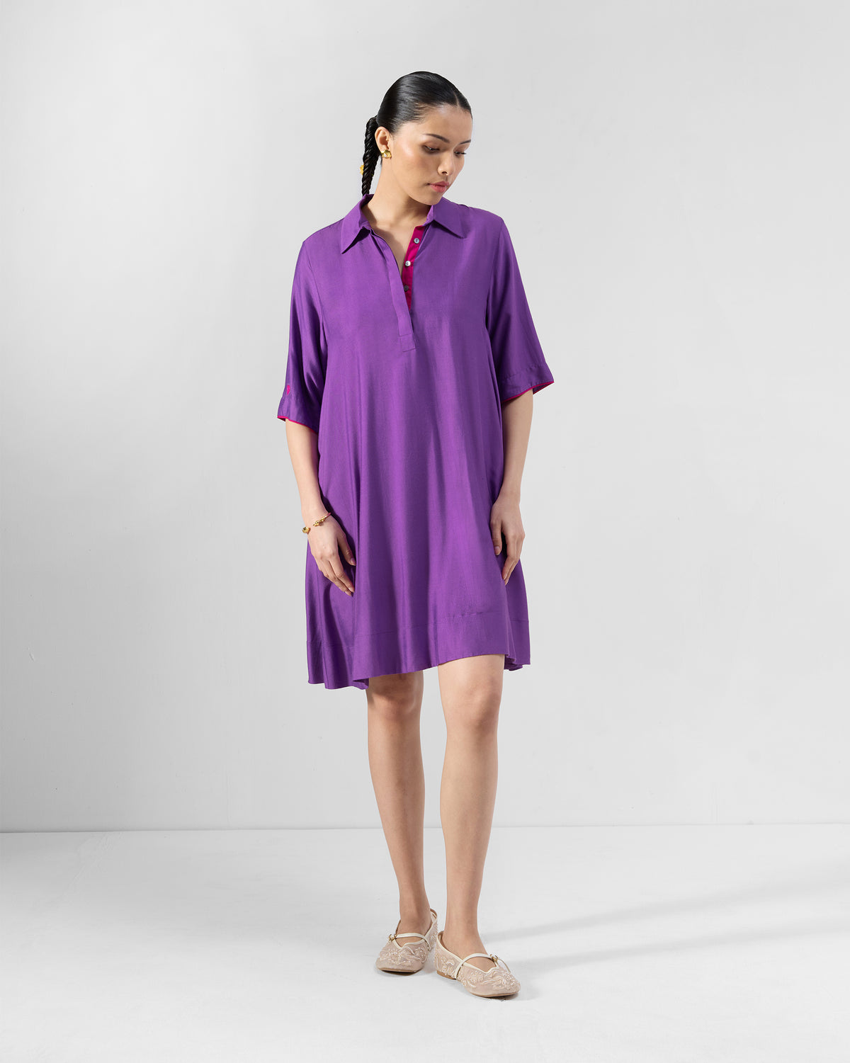 Person wearing a purple Happy Heart Dress with short sleeves and an A-line hem.