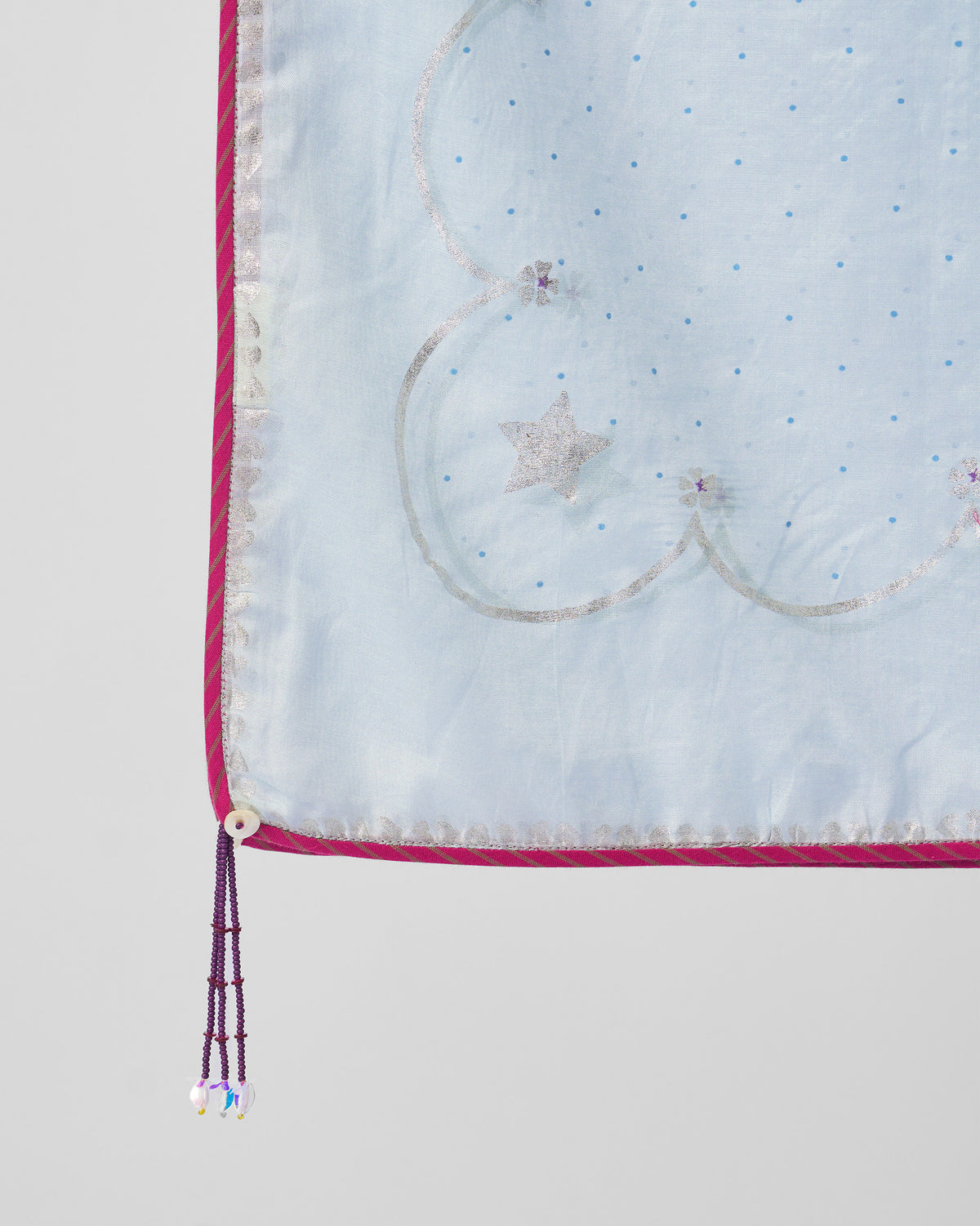 Close-up of Kera Dupatta corner with silver scalloped border and beaded tassel.
