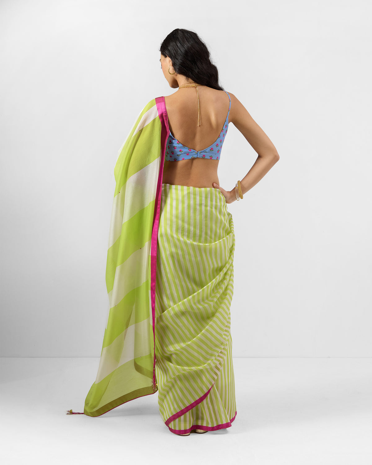Back of a lime and ivory striped Veha sari with a magenta border.
