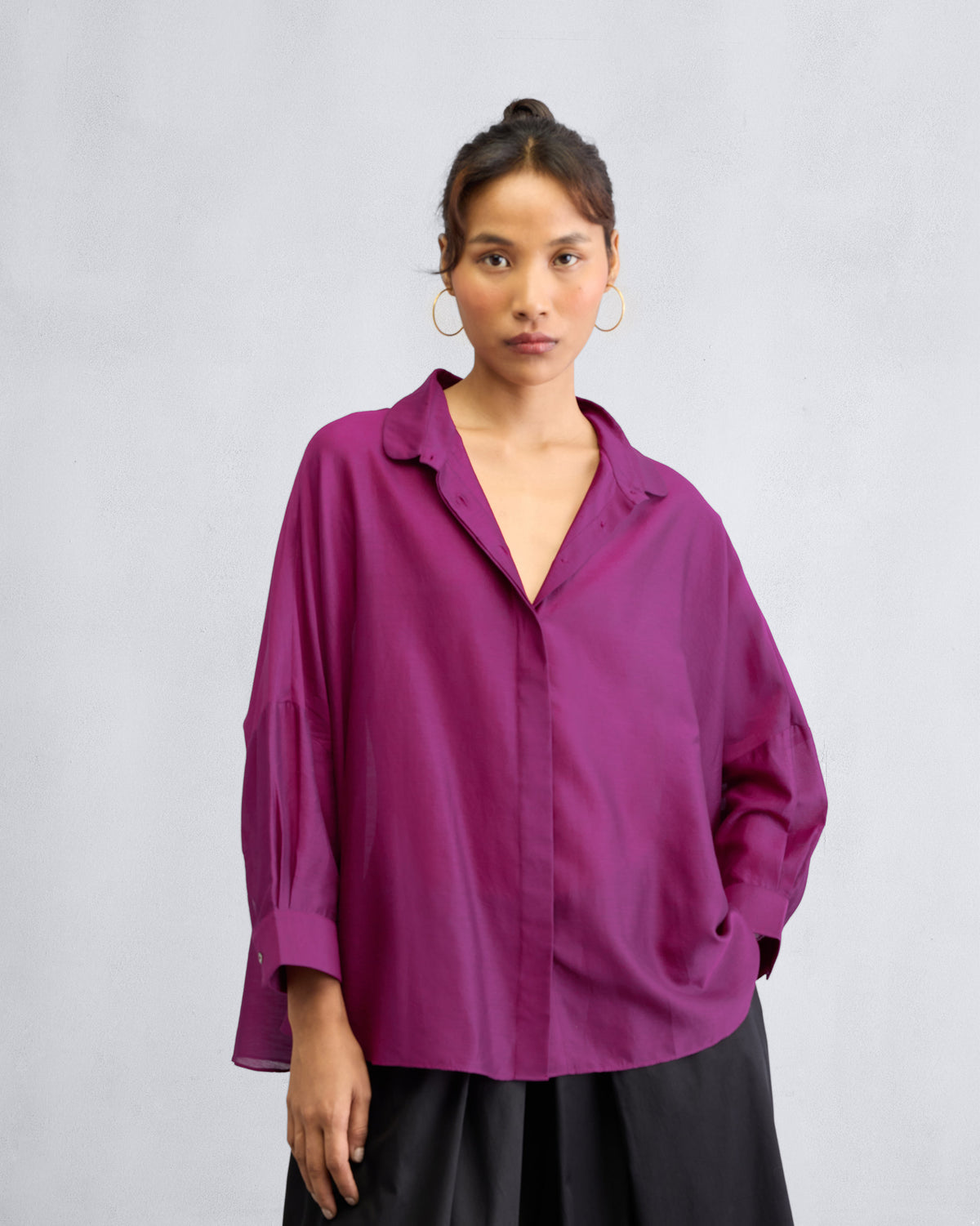 Person wearing a mulberry boxy shirt with a collar, concealed placket, and dropped shoulders.