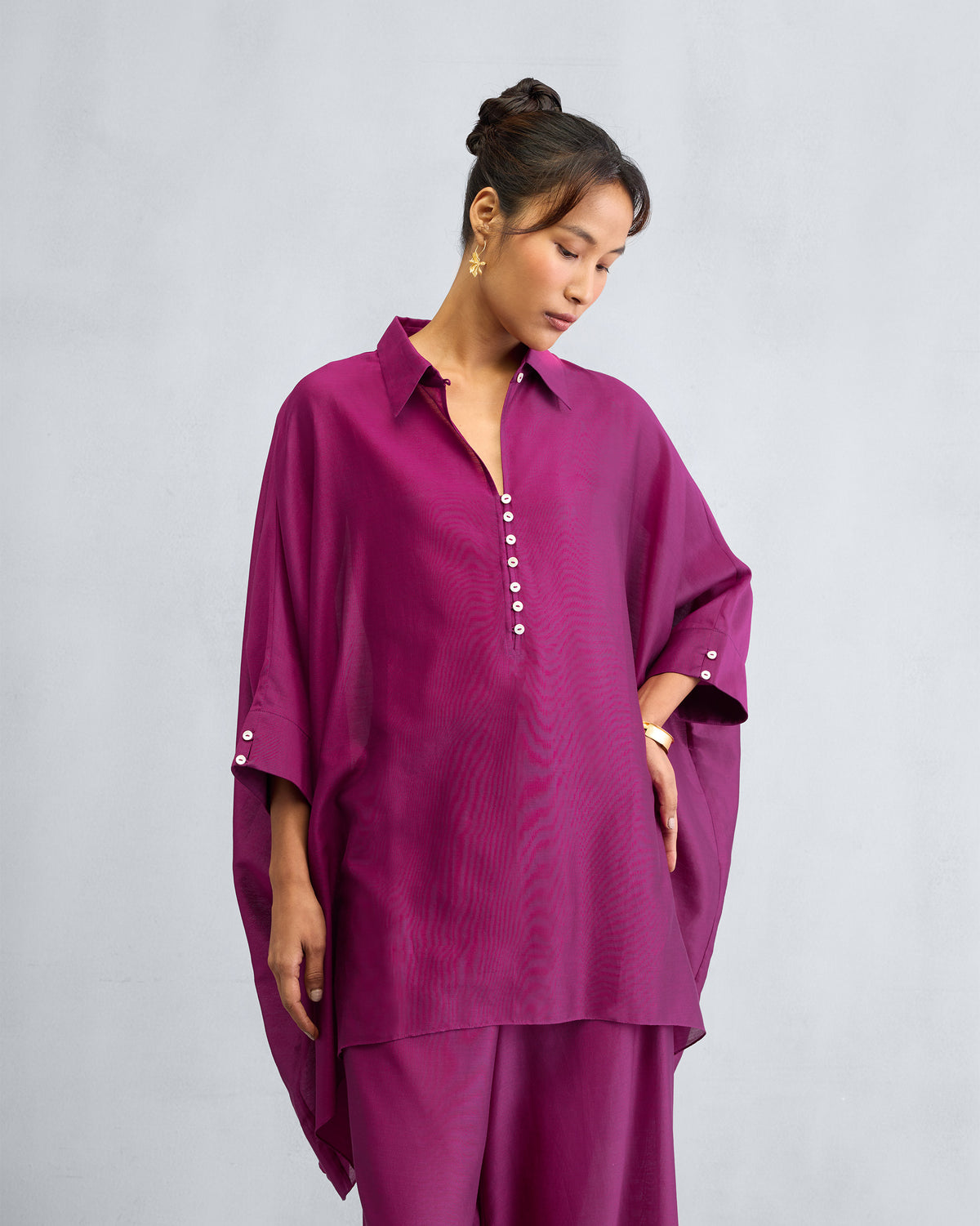 Full-length mulberry Hala tunic with a deep V-neck and white buttons.