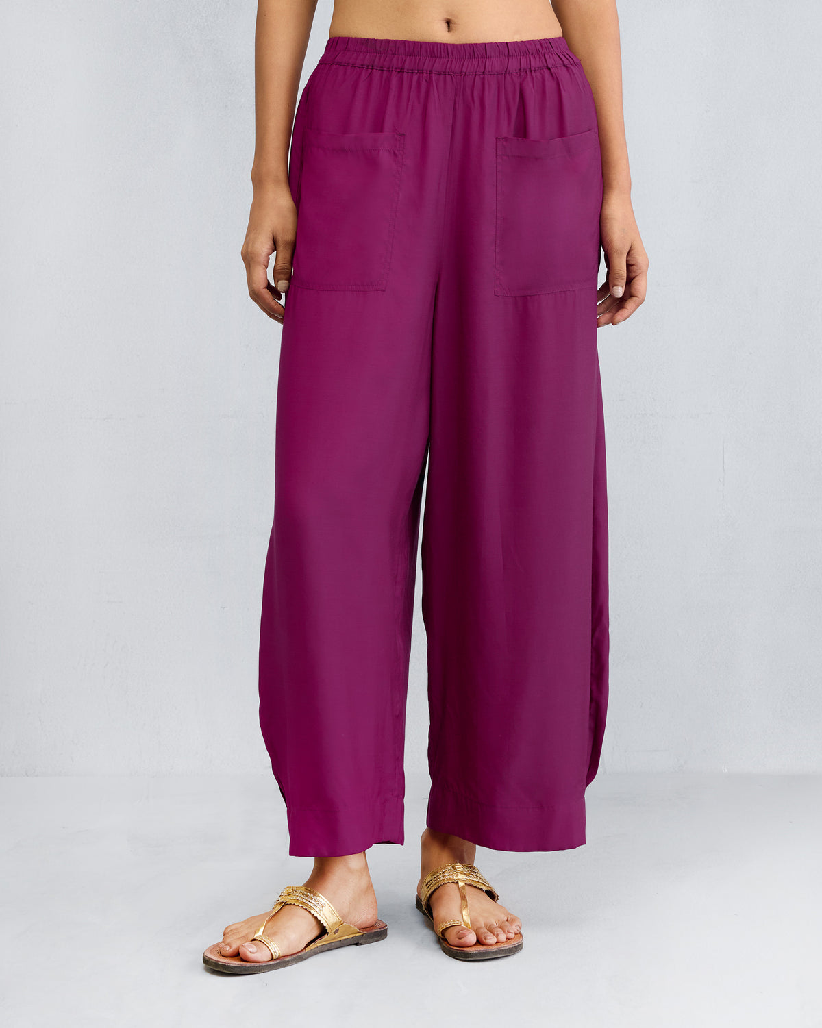 Person wearing mulberry Serene pants with wide legs and patch pockets.