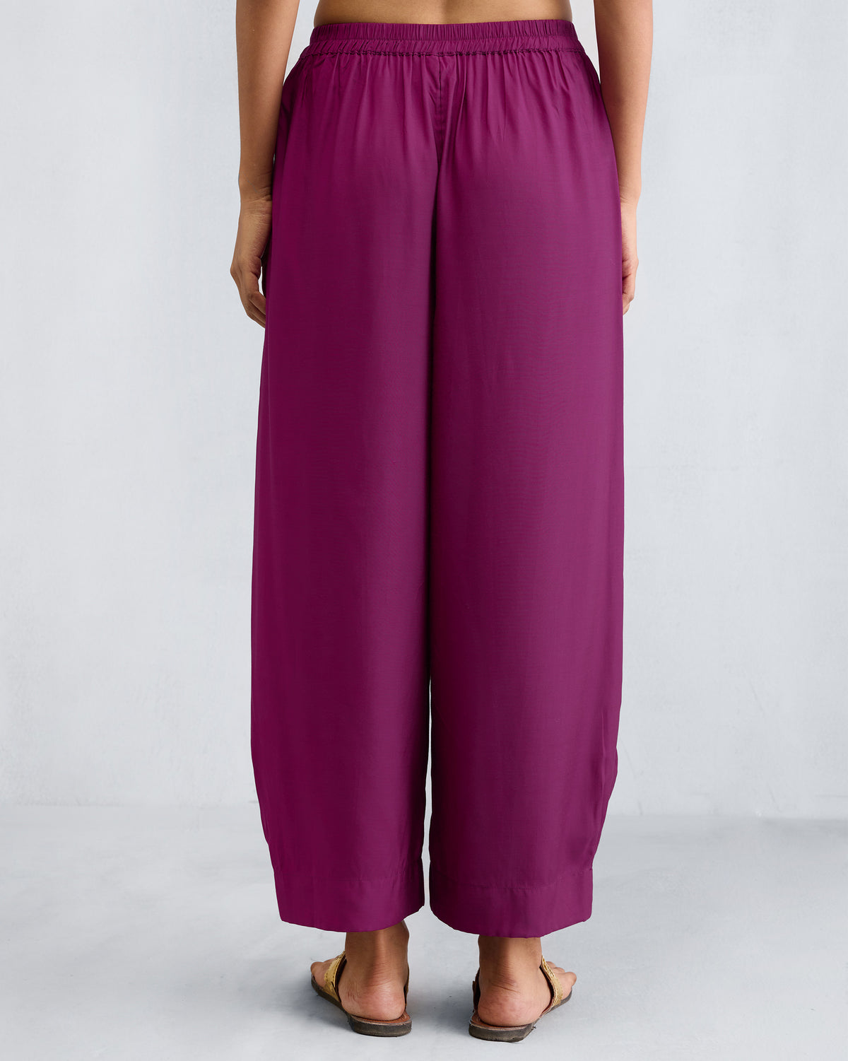 Back of mulberry Serene pants worn by a person.