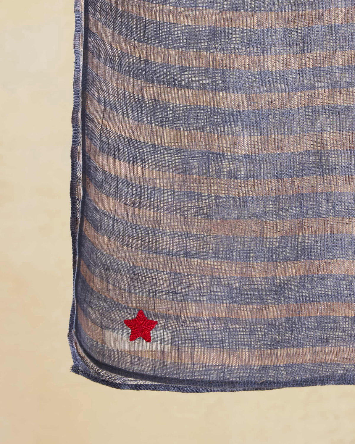 Close-up of the Firefly Scarf's corner with a red star embroidery.
