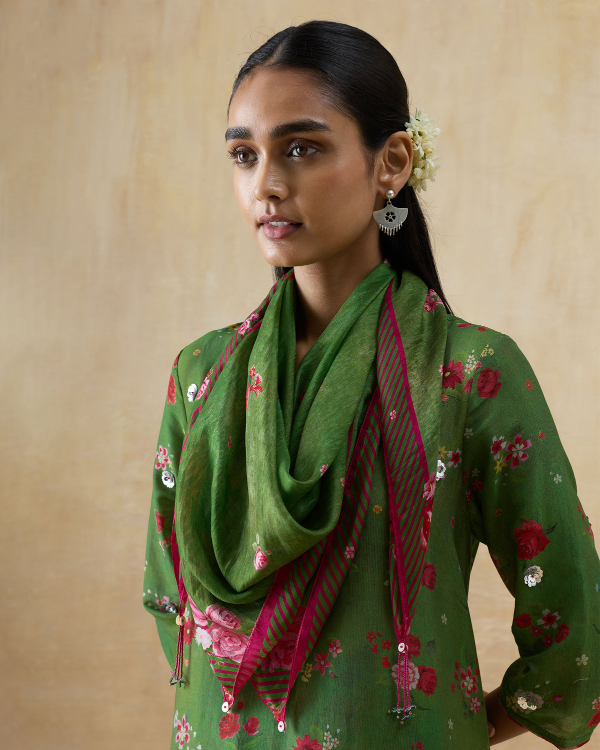 Person wearing the Bouquet Scarf in green with a pink border draped at the neck.