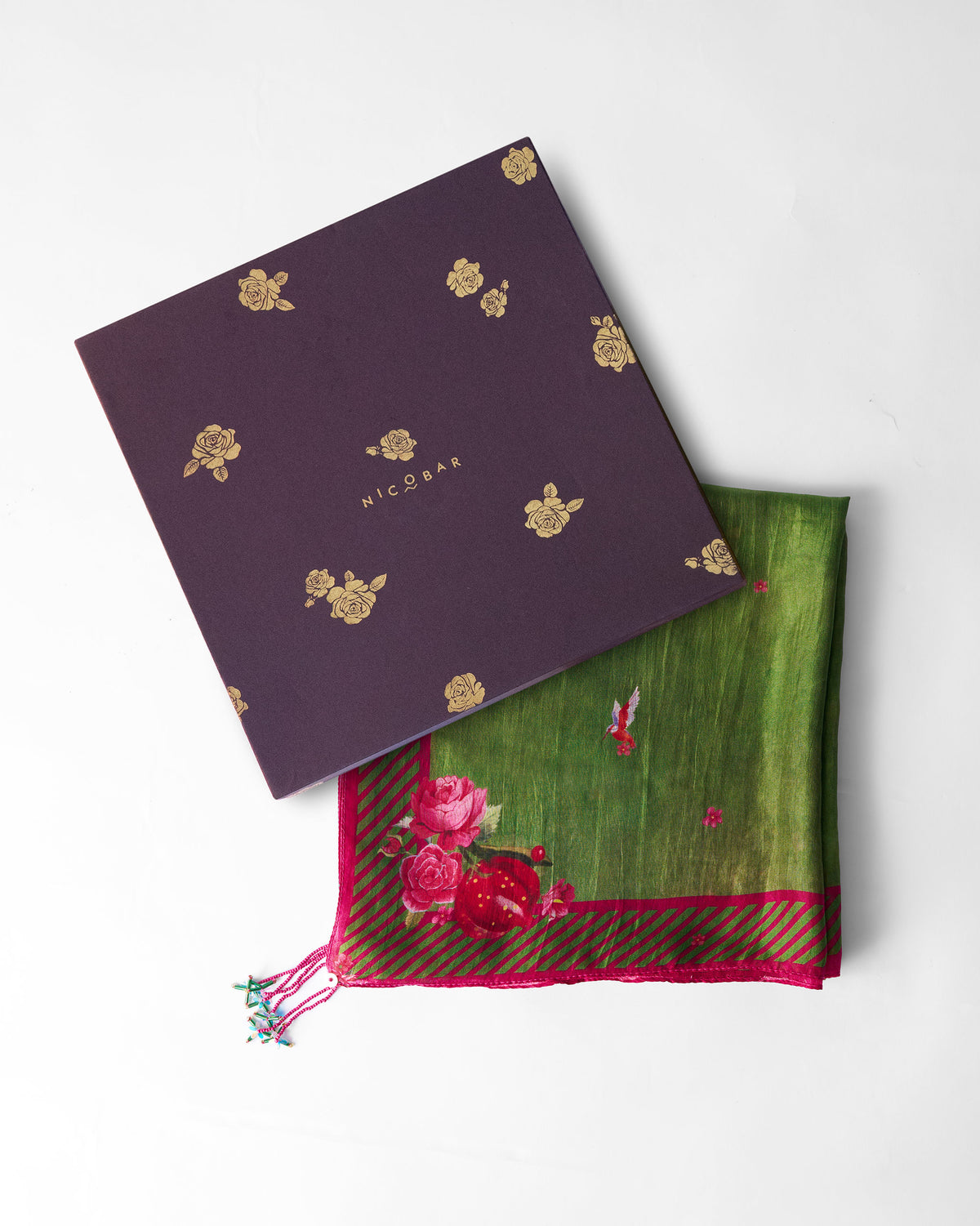Bouquet Scarf in green folded beside a purple Nicobar gift box.