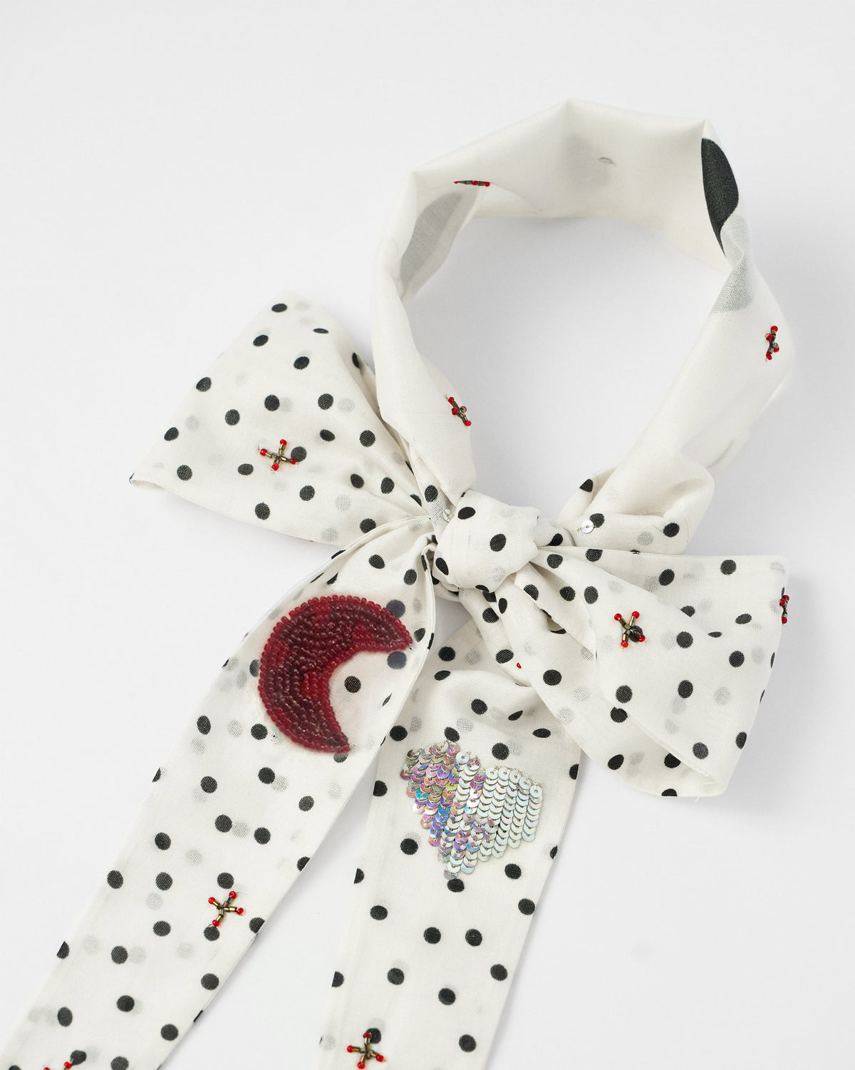 Ivory polka-dot scarf bow with a beaded crescent moon and sequin heart.