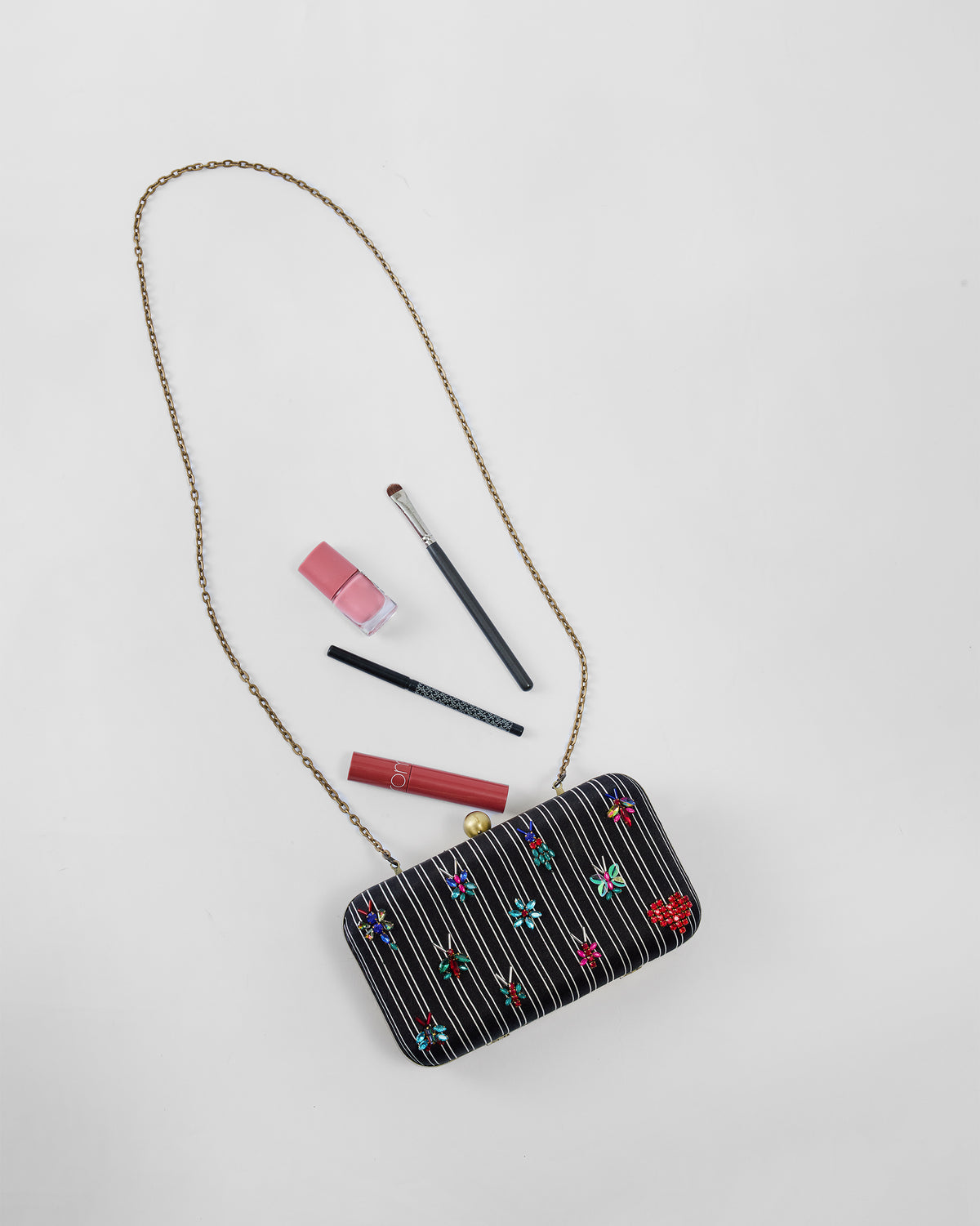 Black embroidered Martini Clutch with beaded bugs and a red heart.