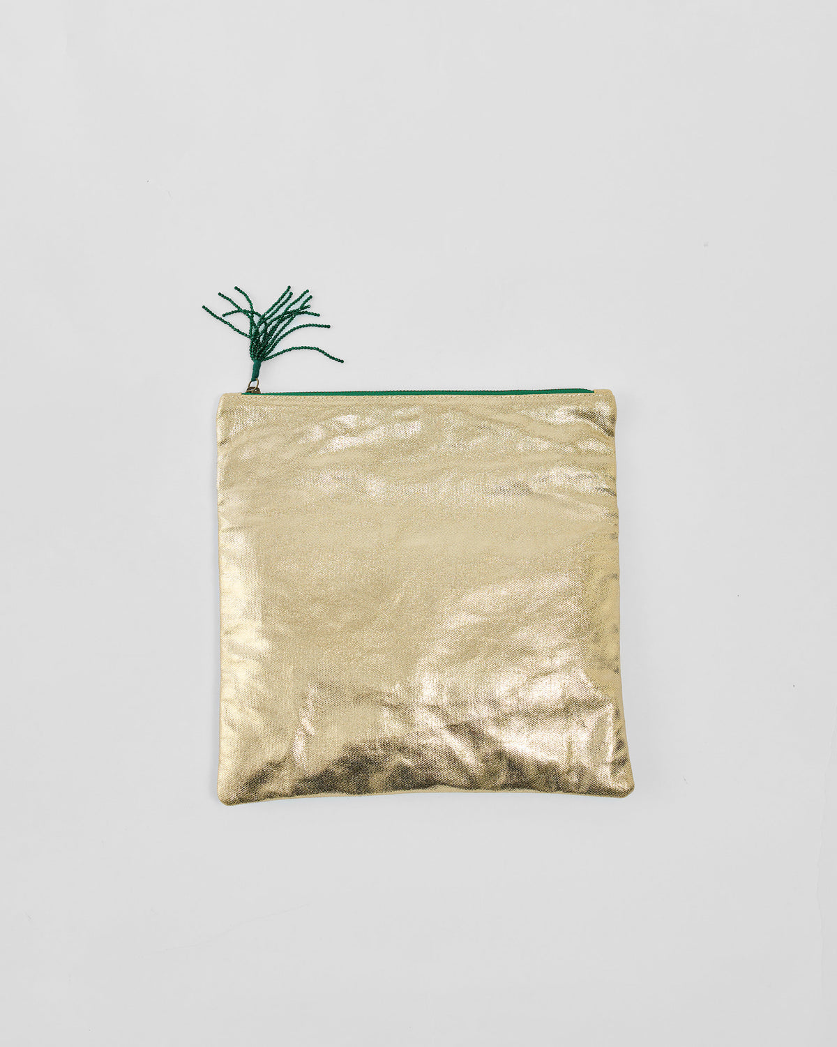 Gold Fold Over Clutch with a green zipper and tassel.