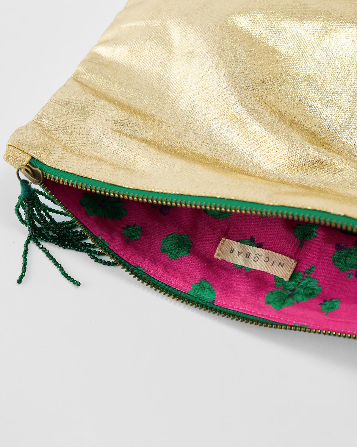 Open gold Fold Over Clutch showing pink floral lining.