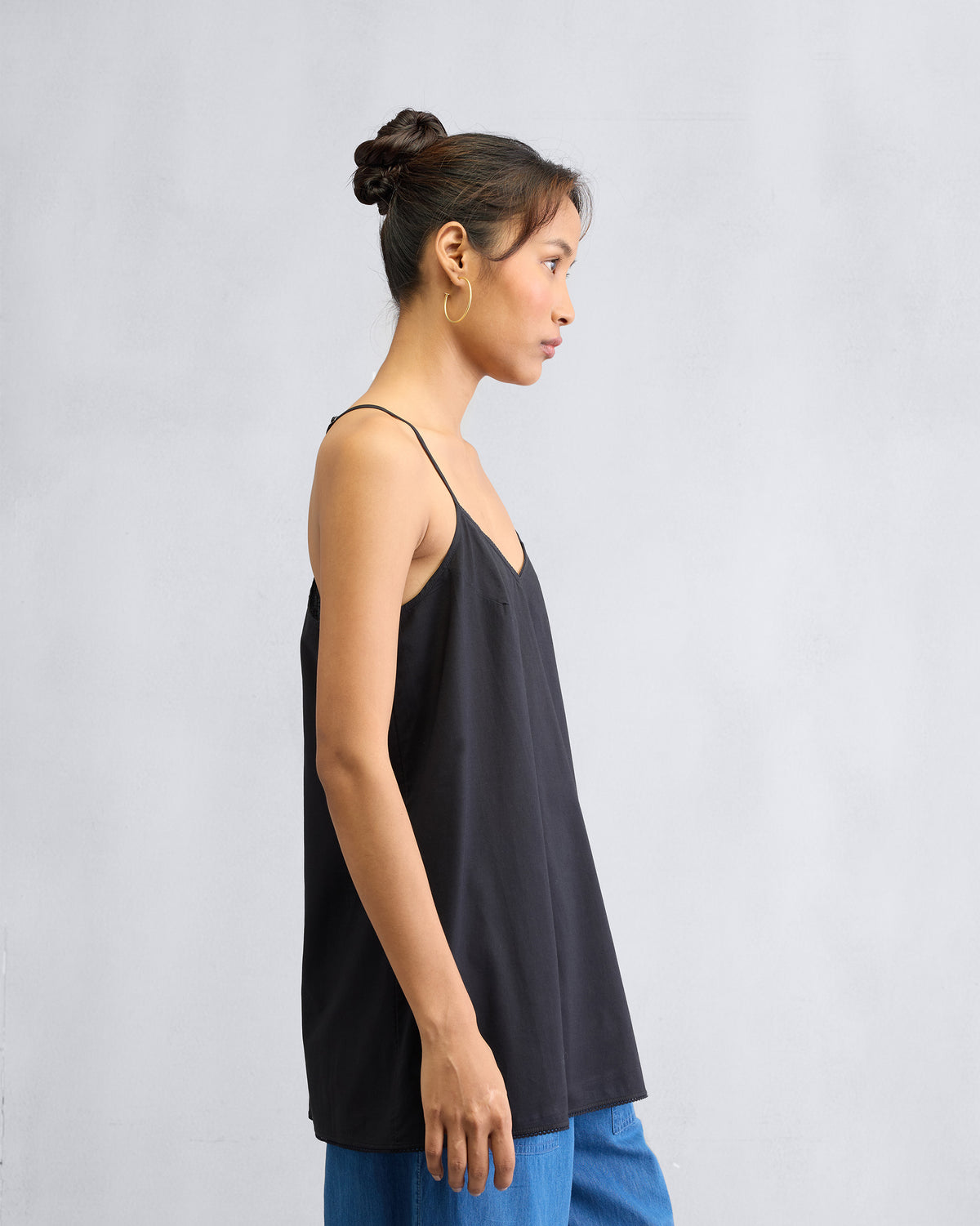 Side view of a black Afra Camisole with spaghetti straps.