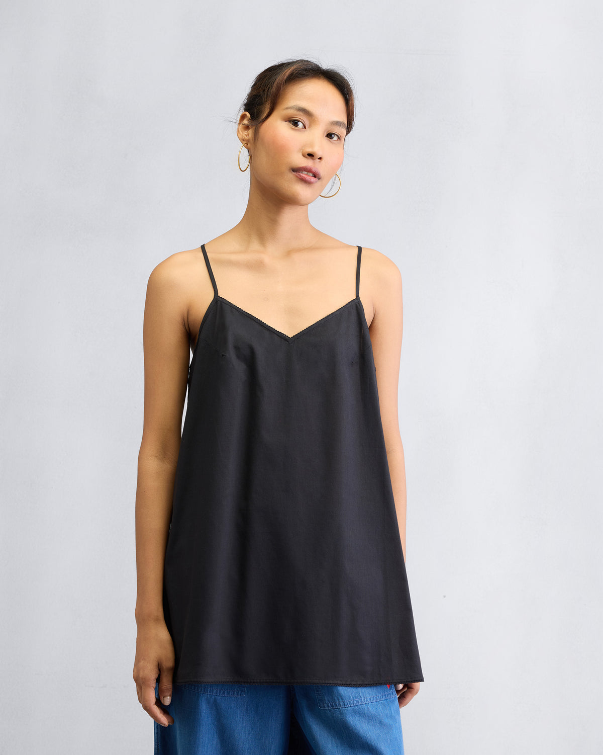 Black Afra Camisole with a V-neck worn hip length.