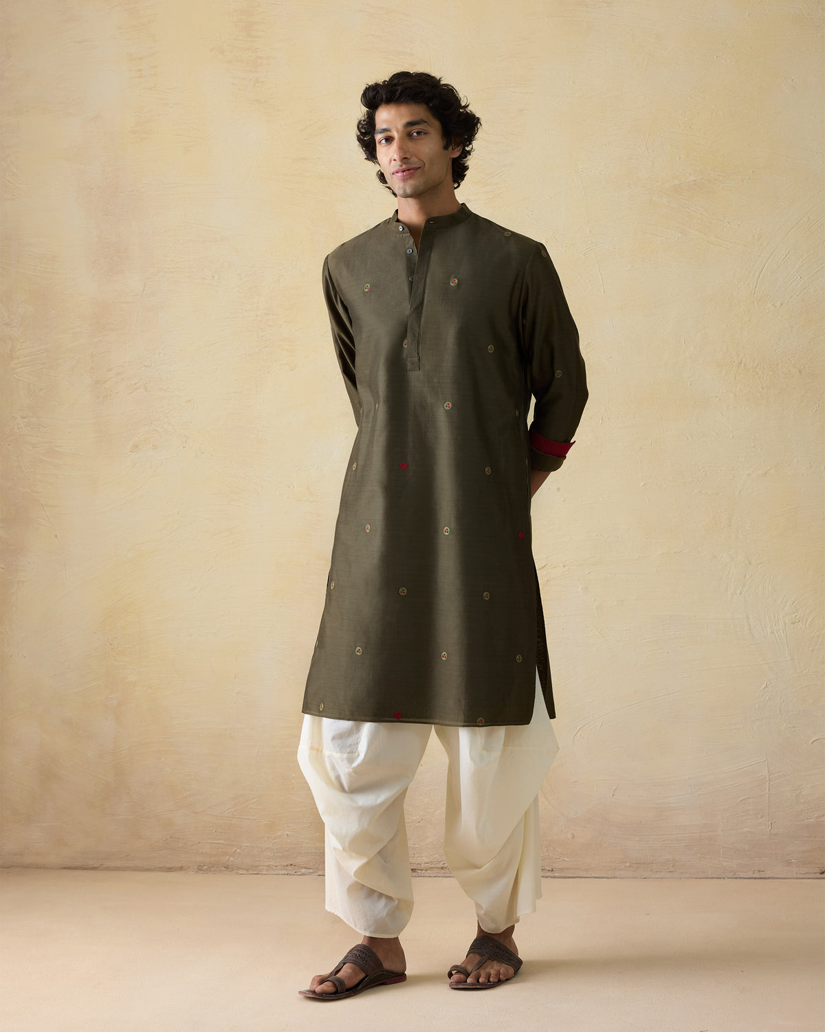 Olive green Neckband Kurta with circular embroidery and red cuff lining.