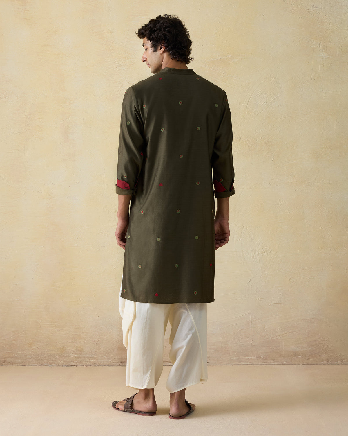 Back of an olive green Neckband Kurta with scattered circular embroidery.