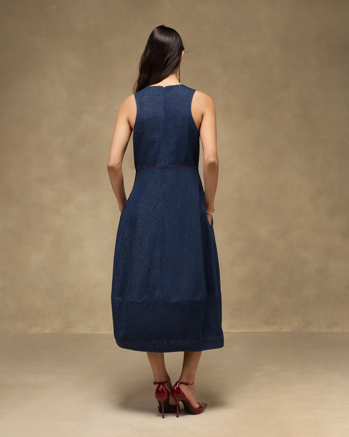 Back of a sleeveless navy denim Sway dress with a fitted waist seam.