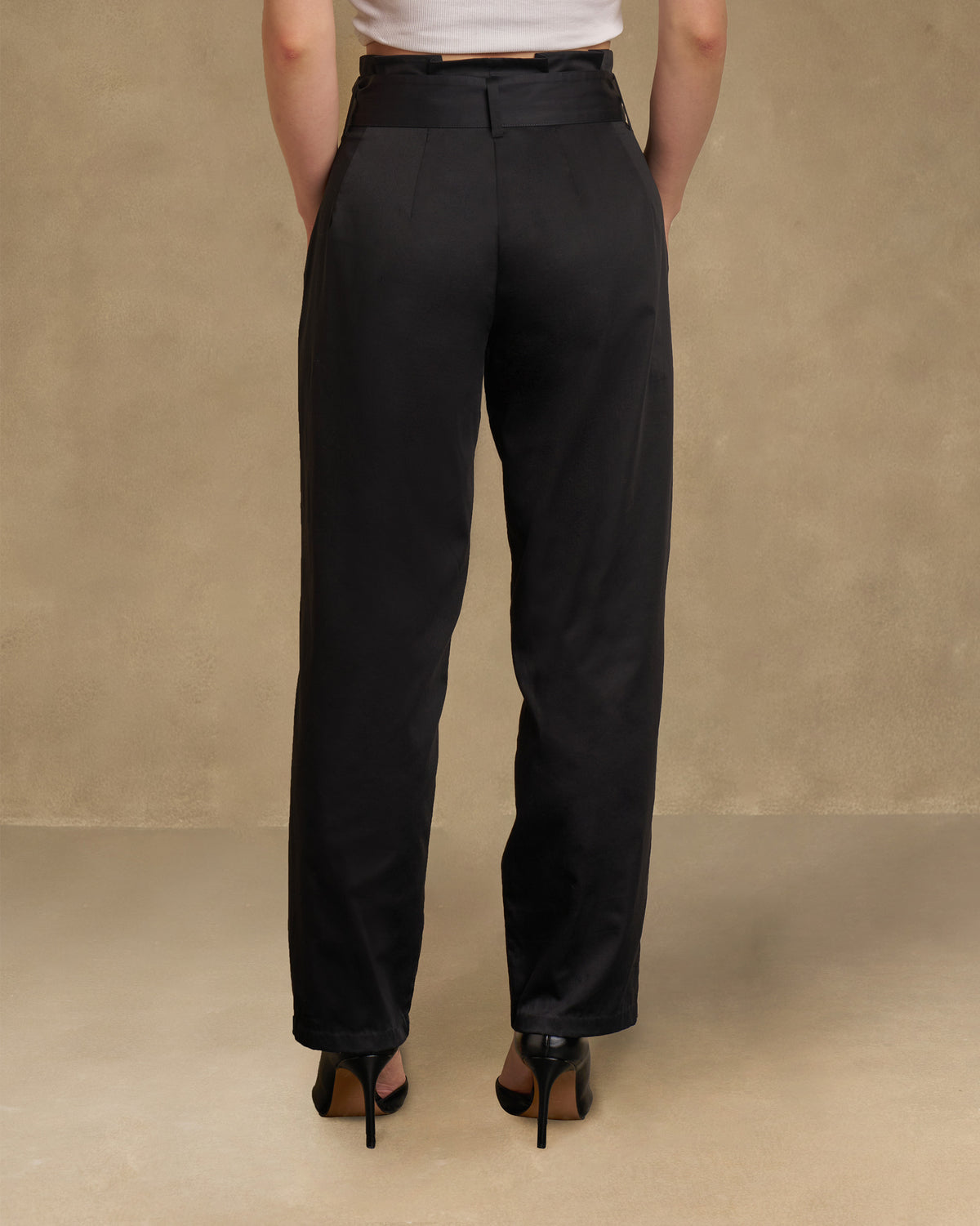 Back of black Gumdrop Pants with a high waist and narrow legs.