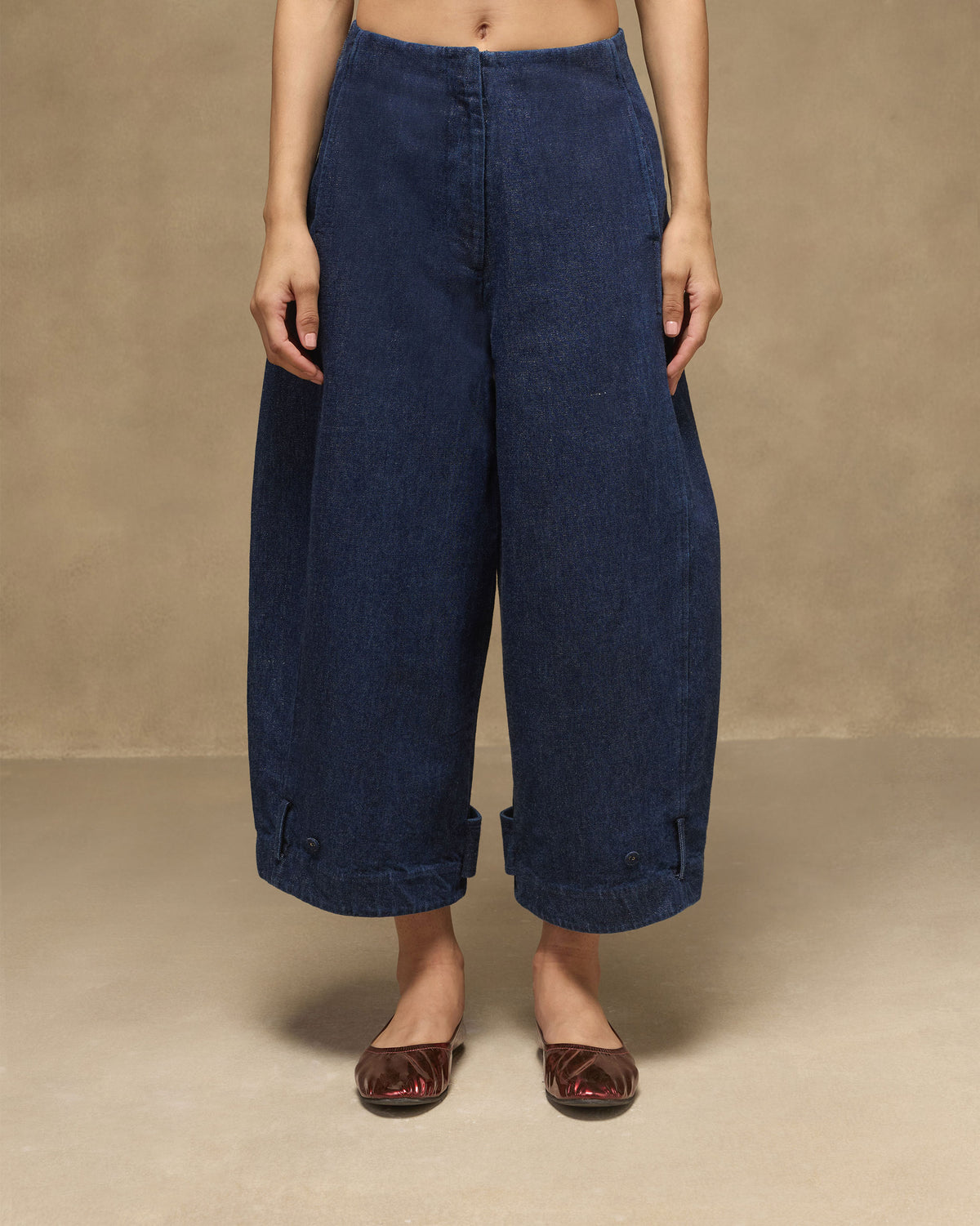 Navy Groove Pants in a relaxed wide-leg denim fit with button-tab cuffs.