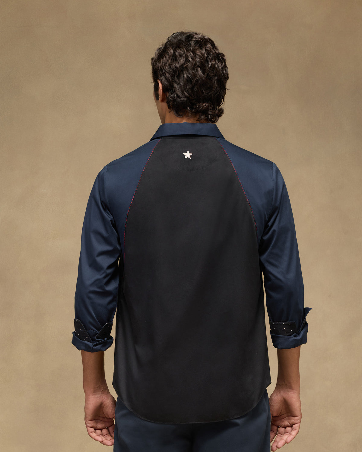 Back of a black-and-navy Moonrise shirt with a white star at the yoke.