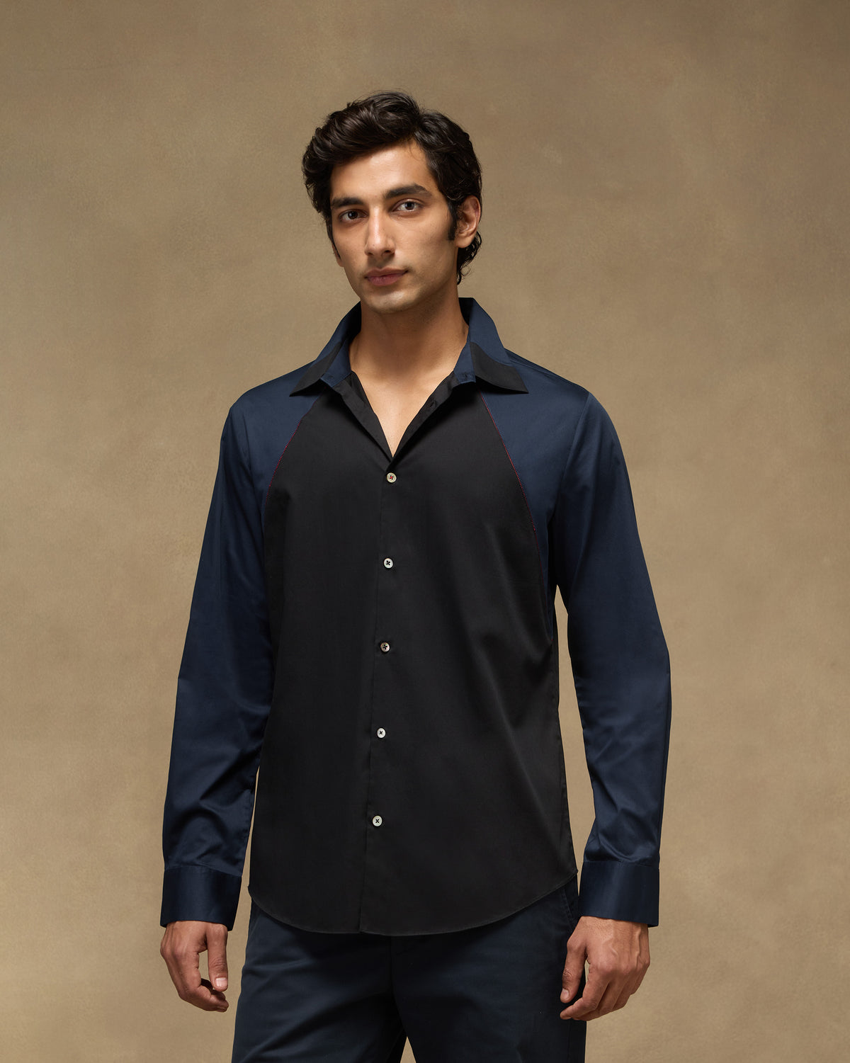 Person wearing a black-and-navy Moonrise shirt with raglan sleeves.