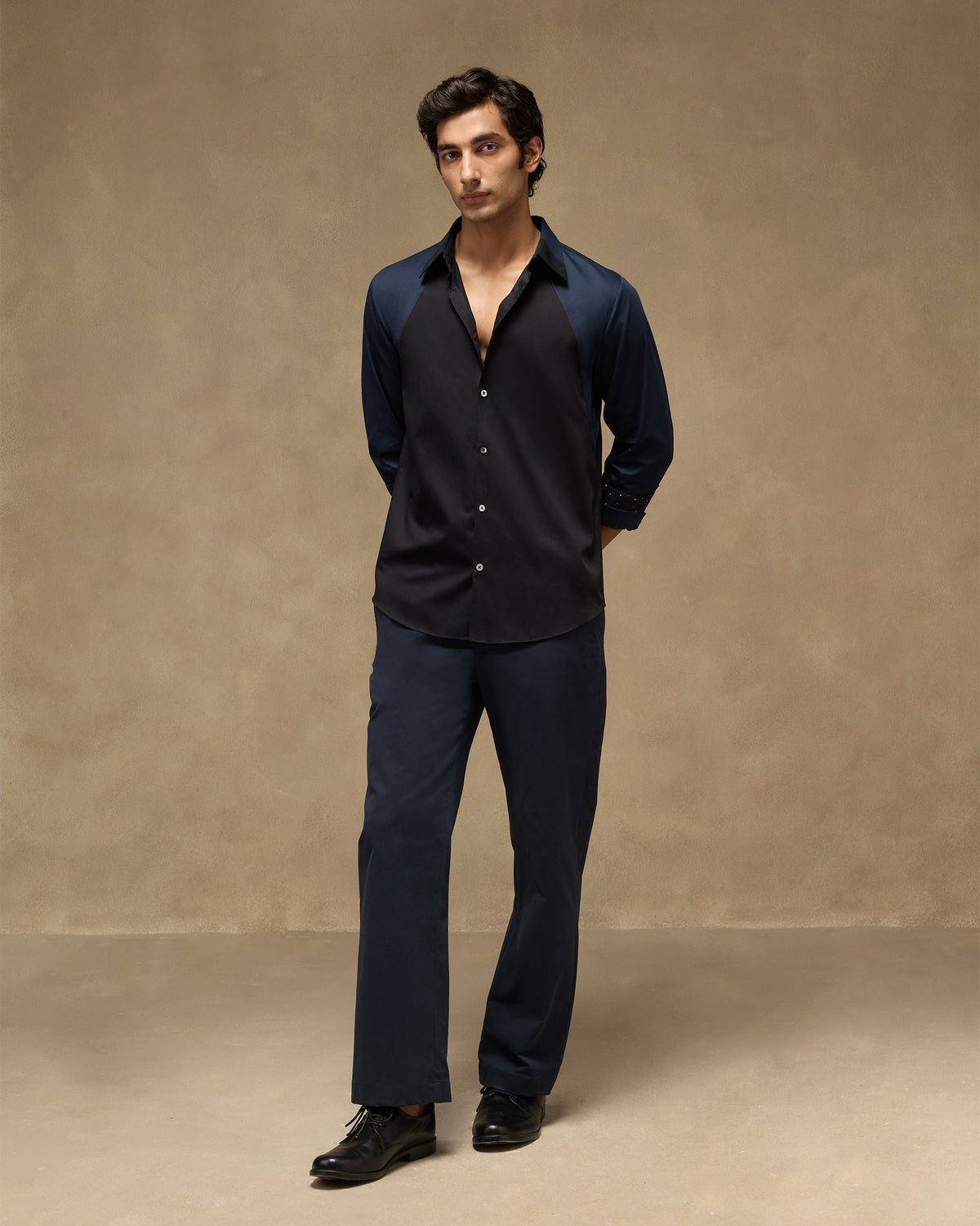 Person wearing a black-and-navy Moonrise shirt with colour-blocked panels.