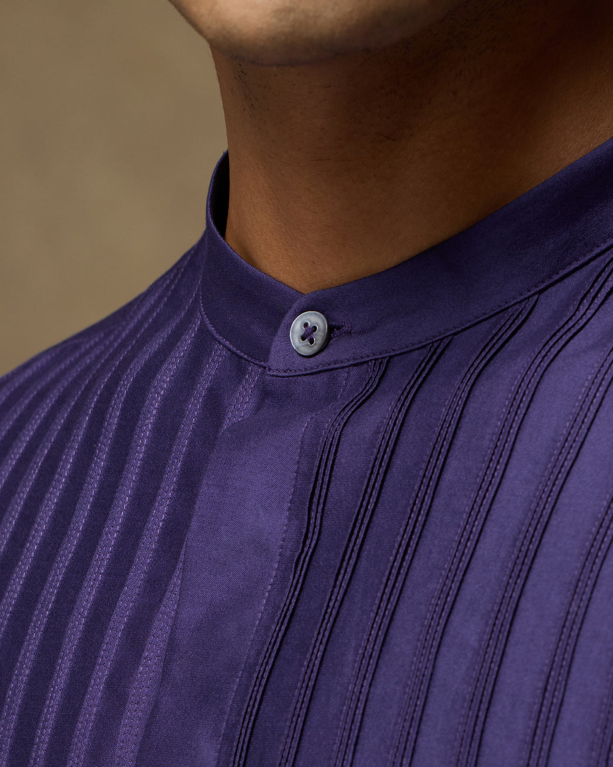 Close-up of Sundown Shirt band collar and vertical pintucks in deep purple.