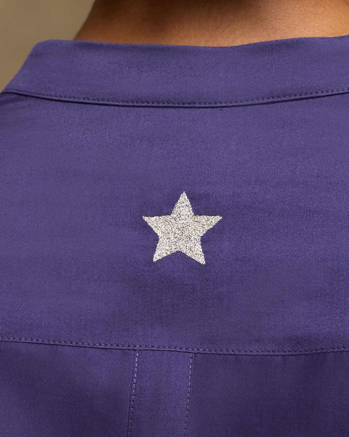 Close-up of Sundown Shirt back yoke with a silver embroidered star.